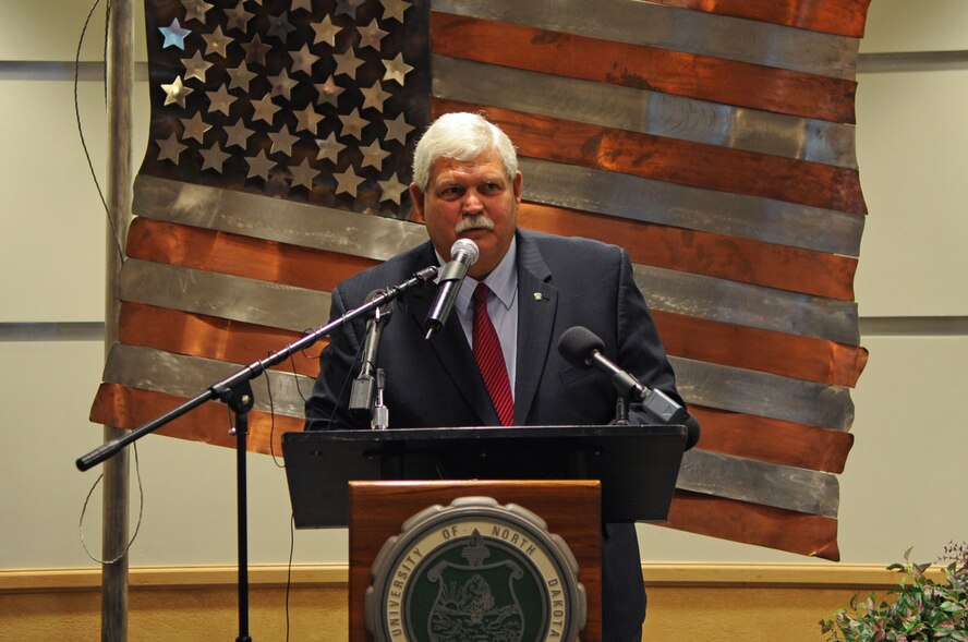 Bruce Smith, Dean of the John D. Odegard School of Aerospace Sciences, speaks to an audience about the dedication of the University of North Dakota Unmanned Aircraft Systems Training Facility opening up on Grand Forks Air Force Base Aug 10. The UND Unmanned Aircraft Systems Center of Excellence was established in 2006 and focuses on education and training for UAS integration into national airspace systems. (U.S. Air Force photo by Senior Airman Amanda N. Stencil)