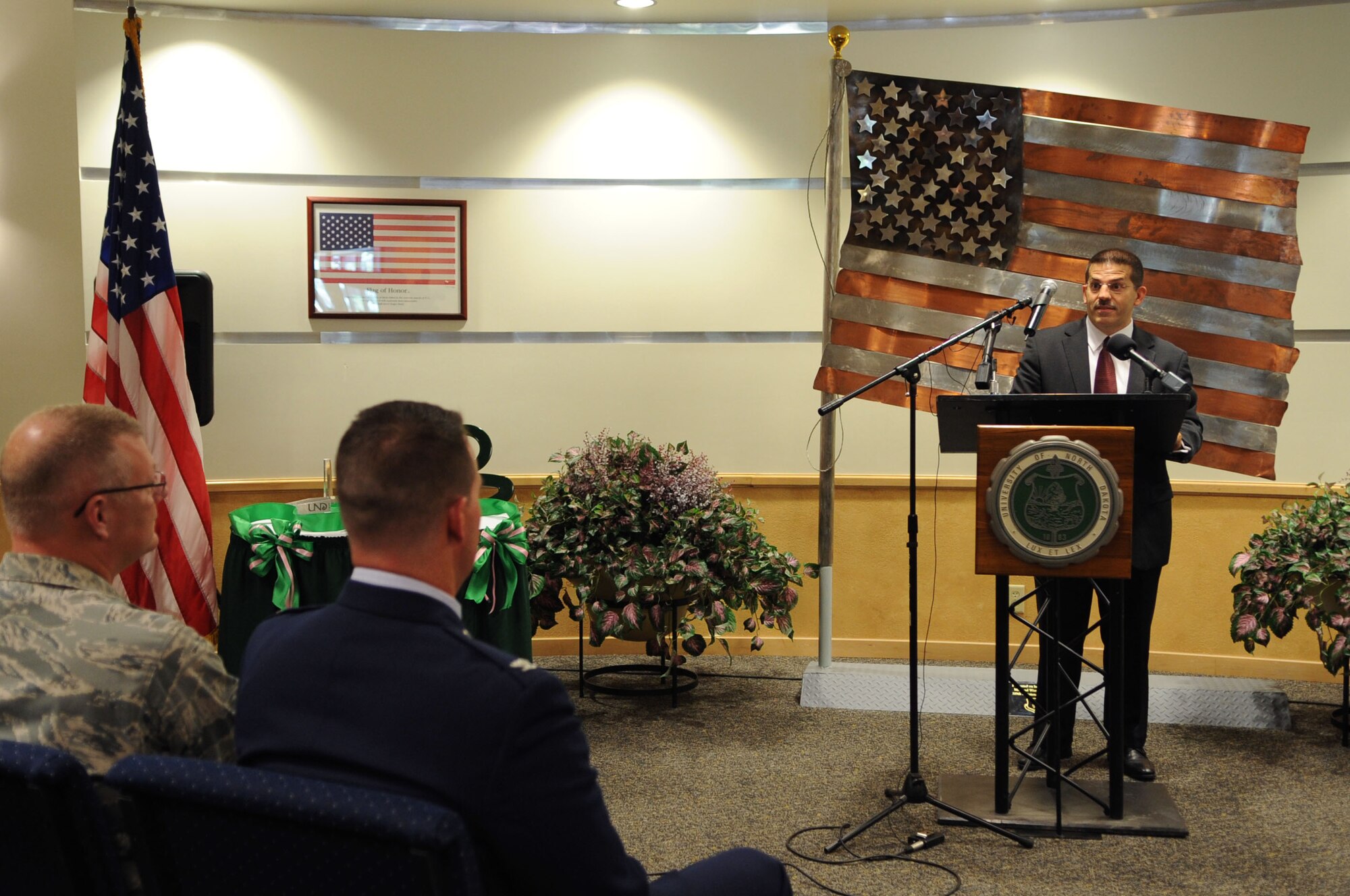 Leonard Genna, president of L-3 Communications, speaks to an audience about the dedication of the University of North Dakota Unmanned Aircraft Systems Training Facility opening up on Grand Forks Air Force Base Aug 10. The UND Unmanned Aircraft Systems Center of Excellence was established in 2006 and focuses on education and training for UAS integration into national airspace systems. . (U.S. Air Force photo by Senior Airman Amanda N. Stencil)
