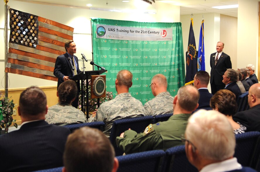 Rep. Rick Berg, congressman from North Dakota, speaks to an audience about the dedication of the University of North Dakota Unmanned Aircraft Systems Training Facility opening up on Grand Forks Air Force Base Aug 10. The UND Unmanned Aircraft Systems Center of Excellence was established in 2006 and focuses on education and training for UAS integration into national airspace systems. . (U.S. Air Force photo by Senior Airman Amanda N. Stencil)