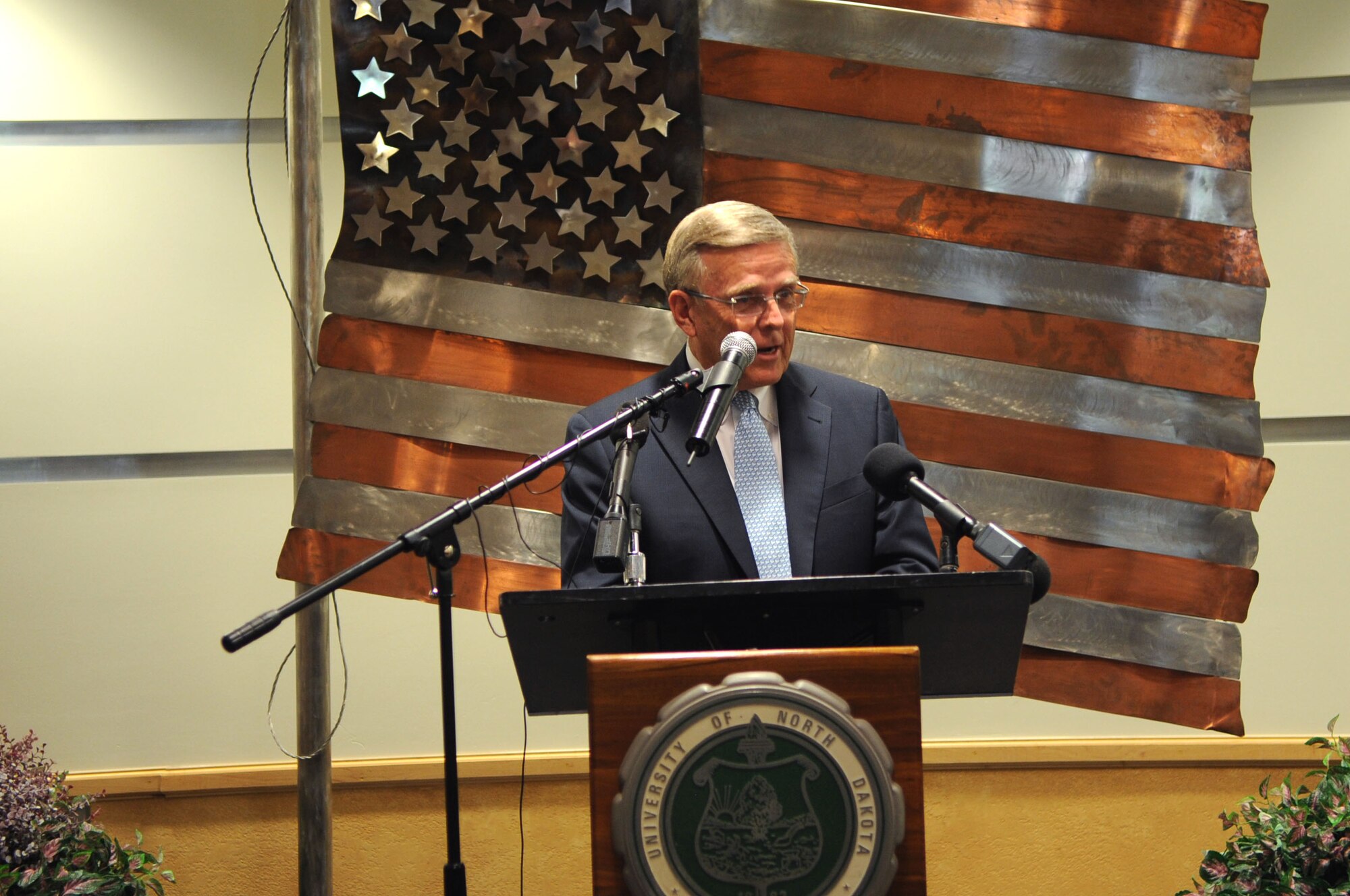 Sen. Byron Dorgan, former senator of North Dakota, speaks to an audience about the dedication of the University of North Dakota Unmanned Aircraft Systems Training Facility opening up on Grand Forks Air Force Base on Aug 10. The UND Unmanned Aircraft Systems Center of Excellence was established in 2006 and focuses on education and training for UAS integration into national airspace systems. . (U.S. Air Force photo by Senior Airman Amanda N. Stencil)