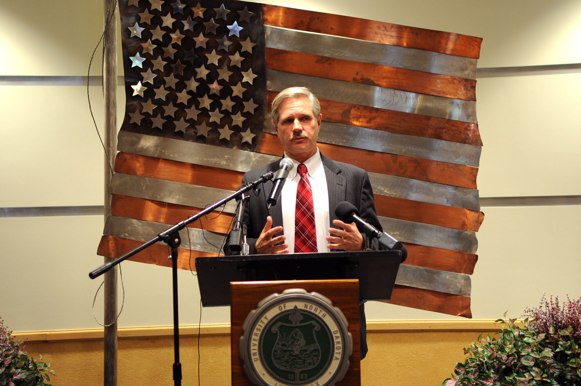 Sen. John Hoeven of North Dakota speaks to an audience about the dedication of the University of North Dakota Unmanned Aircraft Systems Training Facility opening up on Grand Forks Air Force Base on Aug 10. The UND Unmanned Aircraft Systems Center of Excellence was established in 2006 and focuses on education and training for UAS integration into national airspace systems. (U.S. Air Force photo by Senior Airman Amanda N. Stencil)