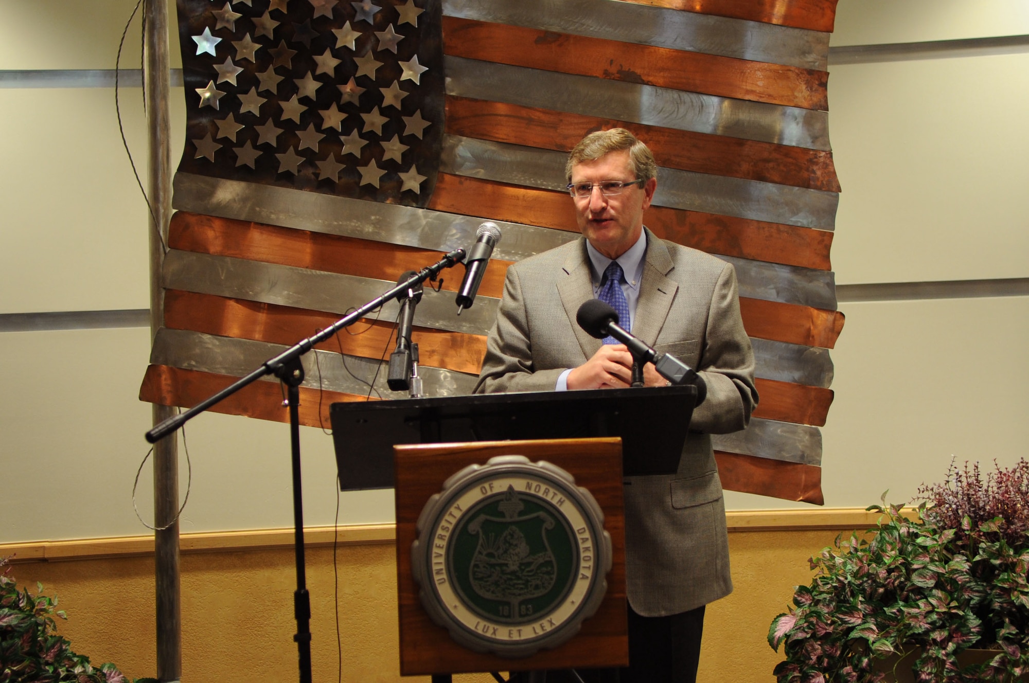 Sen. Kent Conrad, Senator of North Dakota, speaks to an audience about the dedication of the University of North Dakota Unmanned Aircraft Systems Training Facility opening up on Grand Forks Air Force Base on Aug 10. The UND Unmanned Aircraft Systems Center of Excellence was established in 2006 and focuses on education and training for UAS integration into national airspace systems. (U.S. Air Force photo by Senior Airman Amanda N. Stencil)