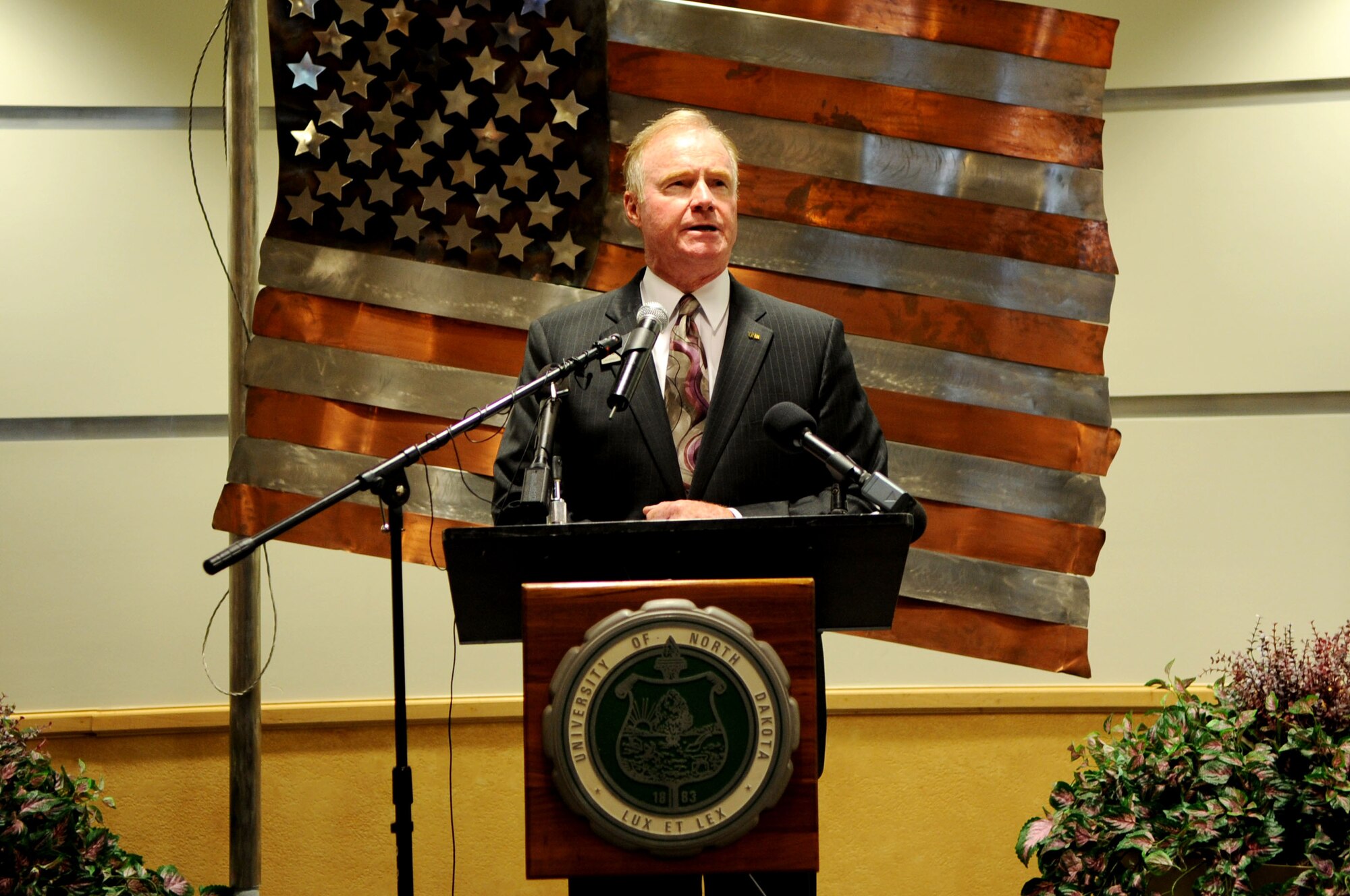 Robert O. Kelley, President of the University of North Dakota, speaks to an audience about the dedication of the UND Unmanned Aircraft Systems Training Facility opening up on Grand Forks Air Force Base on Aug 10. The UND Unmanned Aircraft Systems Center of Excellence was established in 2006 and focuses on education and training for UAS integration into national airspace systems. . (U.S. Air Force photo by Senior Airman Amanda N. Stencil)