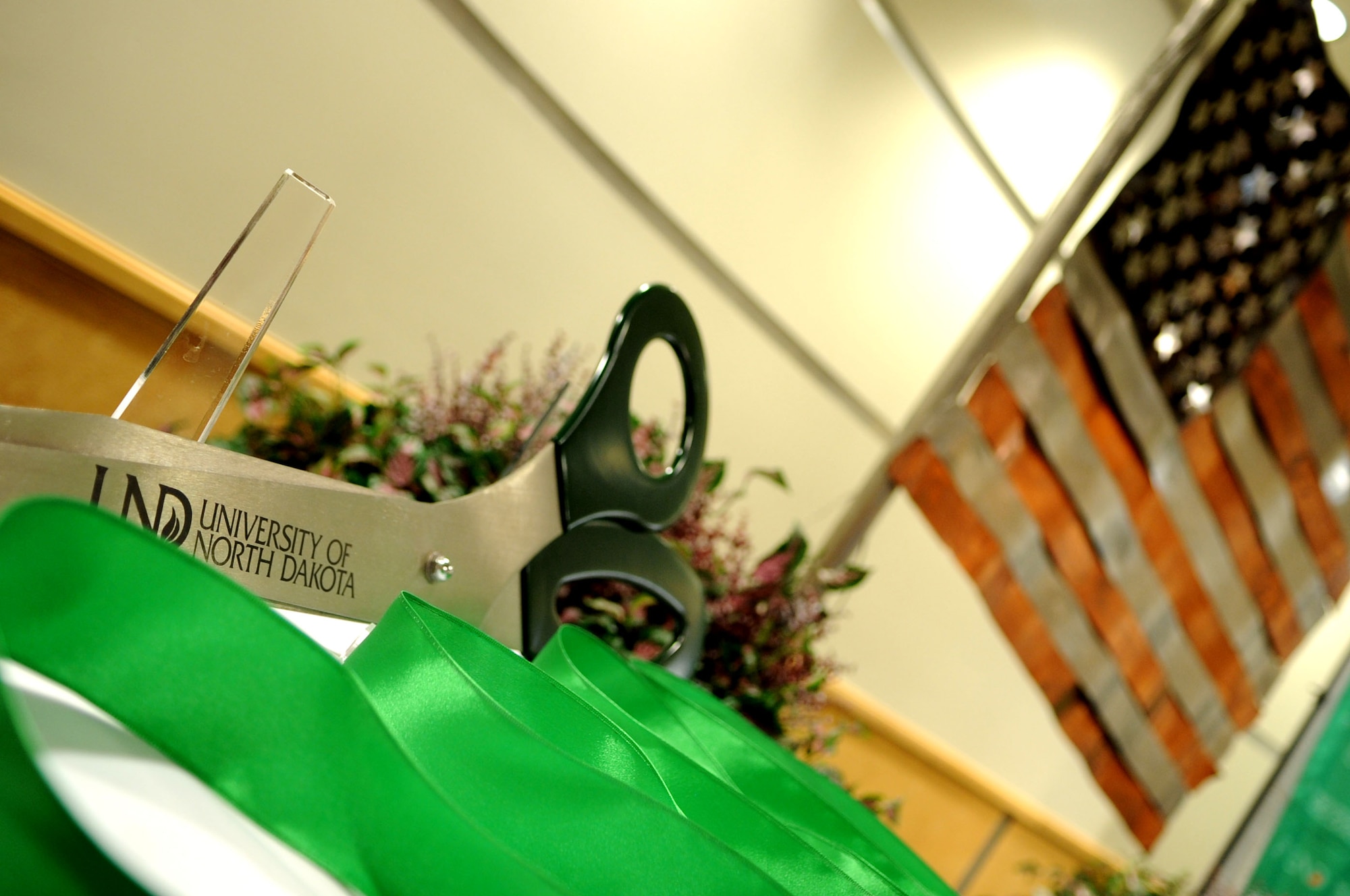 The official ribbon cutting scissors are displayed before the University of North Dakota Unmanned Aircraft Systems Training Facility opens up on Grand Forks Air Force Base  Aug 10. The UND Unmanned Aircraft Systems Center of Excellence was established in 2006 and focuses on education and training for UAS integration into national airspace systems. (U.S. Air Force photo by Senior Airman Amanda N. Stencil)