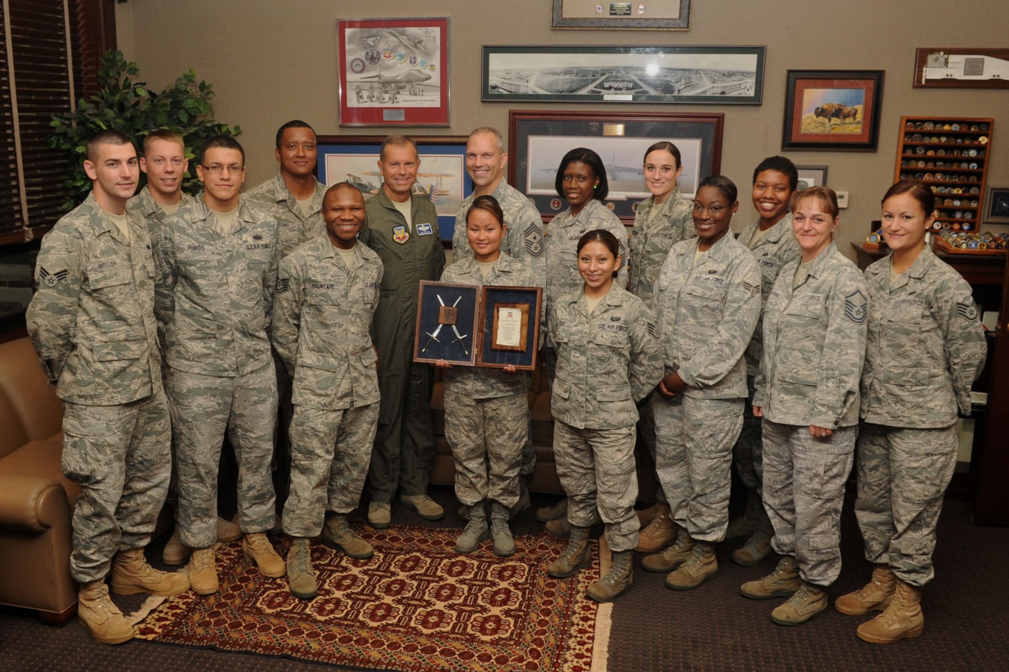 Gen. William M. Fraser III, Air Combat Command commander, poses with the enlisted members of his command section after being presented the invitation to The Order of the Sword Aug. 11, 2011 at Langley Air Force Base, Va. The Order of the Sword was established by the Air Force enlisted force to appreciate and honor military senior officers for significant contributions to the welfare and prestige of the Air Force enlisted force, mission effectiveness as well as the overall military establishment. (U.S. Air Force photo by Airman 1st Class Racheal Watson/Released)