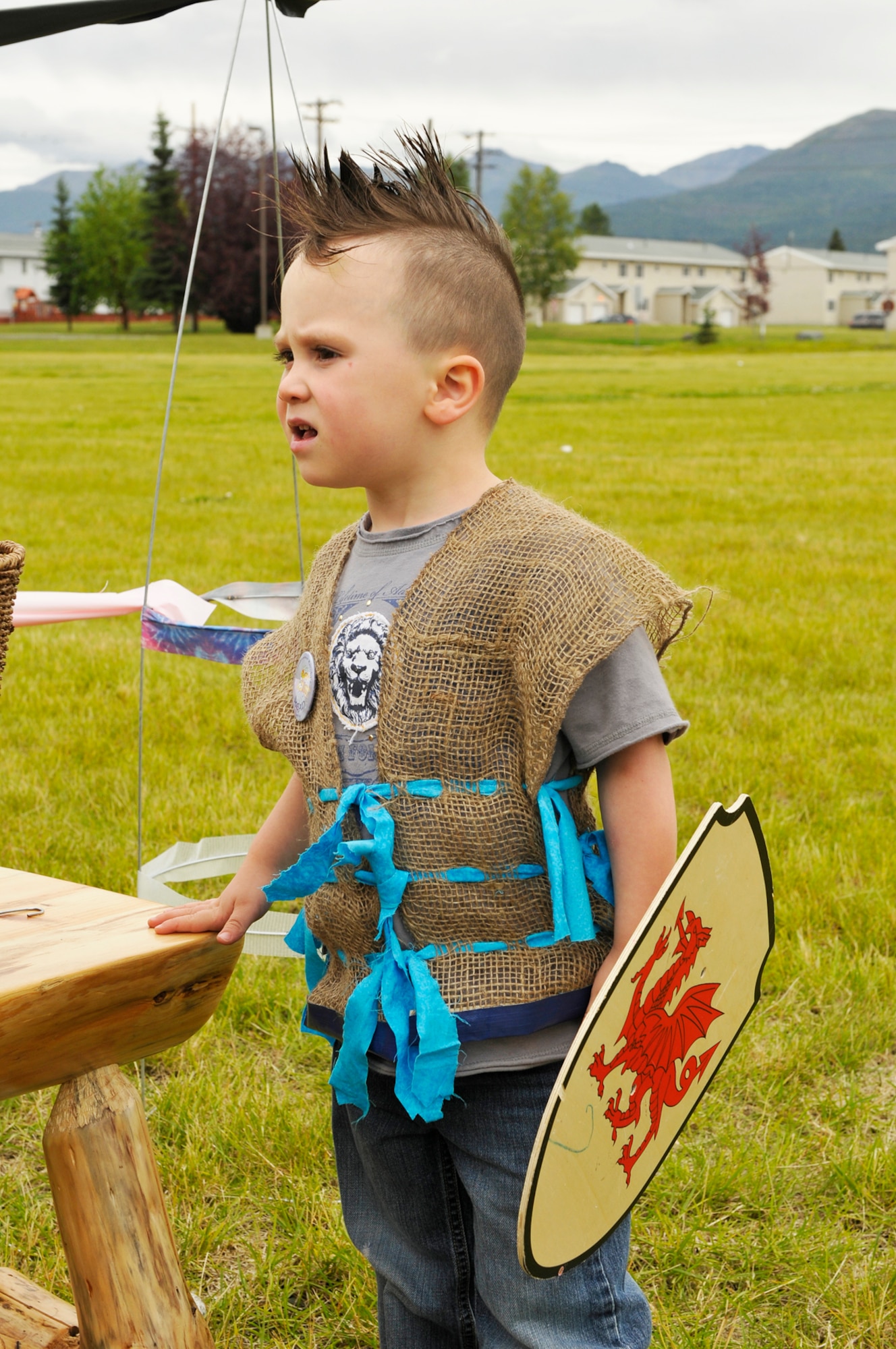 Future warrior Alexander Wright waits his turn for the marshmellow game,  during the  Joint Base Elmendorf-Richardson event "A Midsummer Knights Read" on the grounds of the base library. Activites included shield decorating, hat making and marshmello catapult contest. Members of the local Society for Creative Anachronism were on hand with members dressed in the period and sword fighting in armour was displayed. (U.S. Air Force photo/Steven White) 