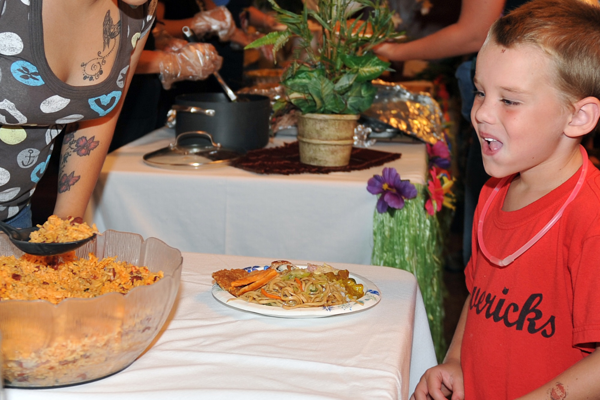 Keegan Thompson, son of Senior Airman Jeffery Thompson from the 97th Intelligence Squadron, eagerly awaits a taste of rice during the 2011 Diversity Day events on Aug. 5, 2011, at Offutt Air Force Base, Neb.  Diversity Day was held at the Community Center and offered attendees an array of dishes from around the world. (U.S. Air Force photo by Jeff W. Gates)