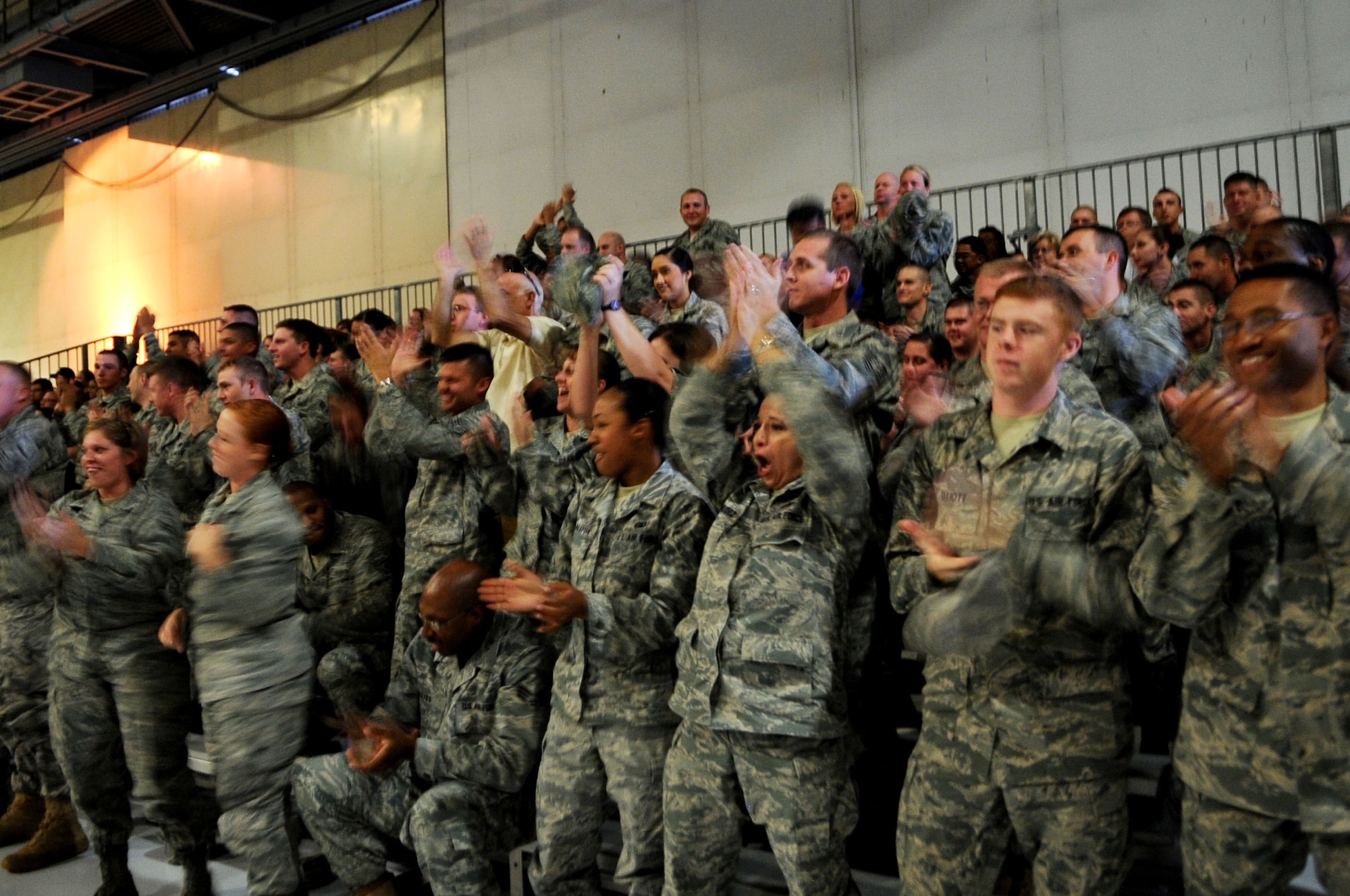 Members of the 319th Logistics Readiness Squadron cheer when they receive an outstanding for their inspection grade during a Compliance Inspection de-brief on GFAFB Aug 9. A CI is an inspection conducted to assess areas mandated by law, as well as mission areas identified by leadership as critical or important to the health and performance of a unit. The 319th Air Base Wing recieved an overall raing of "excellent". (U.S. Air Force photo by Senior Airman Amanda N. Stencil)