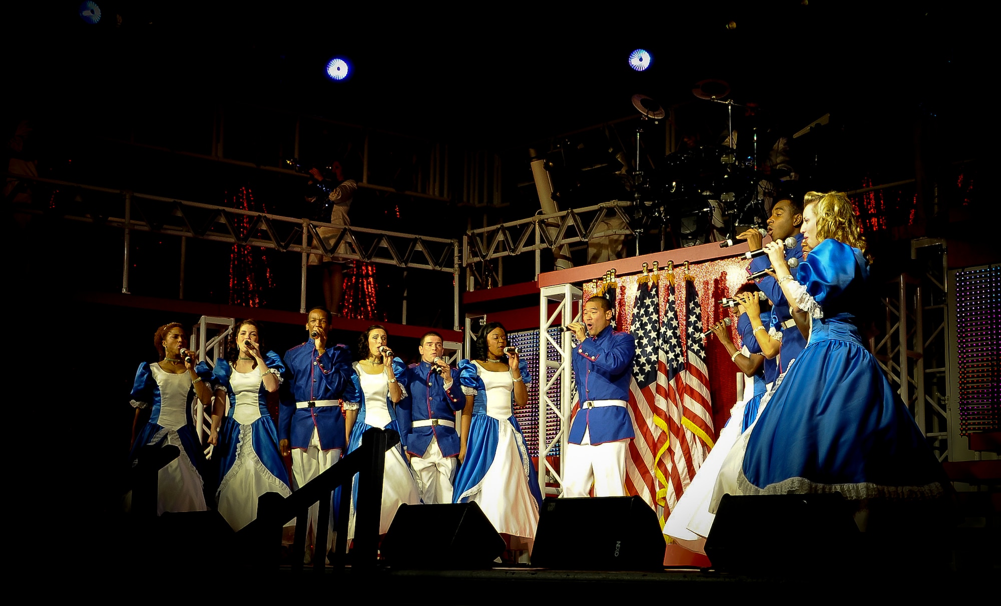 Members of the Air Force’s Tops in Blue sing a patriotic song in unison for the Joint Base McGuire-Dix-Lakehurst community, Aug. 8 at the Timmermann Center. Tops in Blue are the Air Force’s premier entertainment unit, which travels from installation to installation singing, dancing and role playing. The unit took the audience on a musical roller coaster starting with swing and jazz then working their way to today’s current music. (U.S. Air Force photo by Airman 1st Class Dennis Sloan/Released)