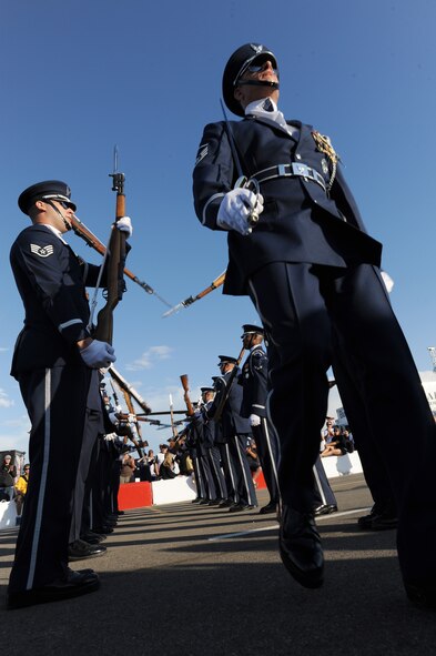 Master Sgt. Nathan Todd, U.S. Air Force Honor Guard Drill Team flight chief, Marches through a barrage of swinging M-1 rifles making it through unscathed Aug. 6, in Saskatoon, Canada. The USAF Honor Guard Drill Team performed at annual Cameco Canada Remembers International Festival for Heroes Air Show. (U.S. Air Force photo by Staff Sgt. Christopher Ruano)
