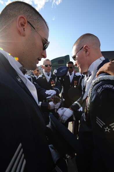 The U.S. Air Force Honor Guard Drill team joins in prayer before the performance Aug. 6, at the annual Cameco Canada Remembers International Festival for Heroes Air Show in Saskatoon, Canada. The prayer brings the team together to motive them before their performances. (U.S. Air Force photo by Staff Sgt. Christopher Ruano)
