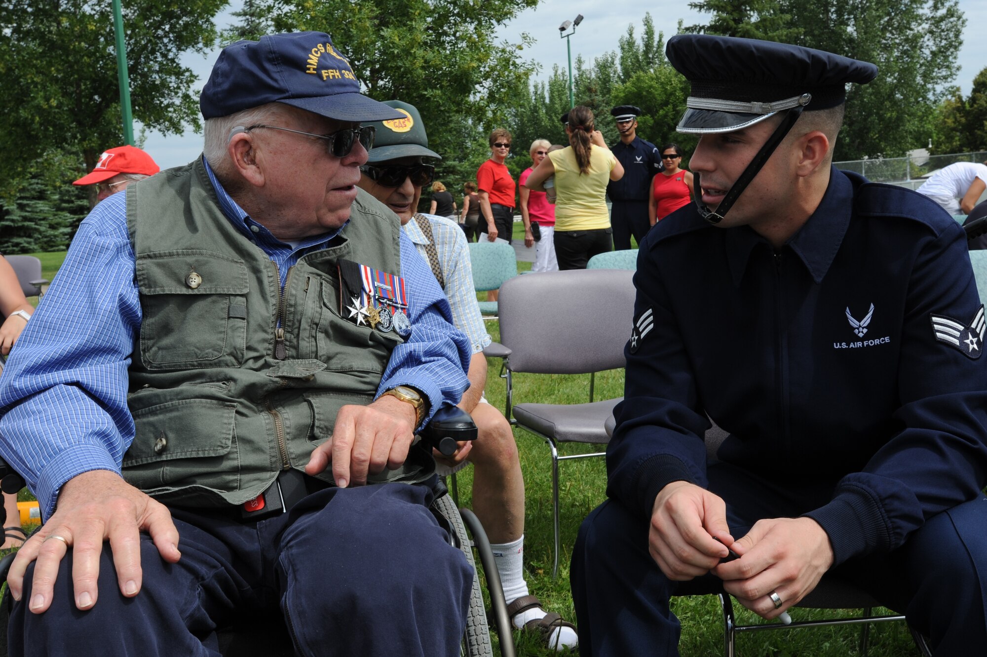 Senior Airmen Christopher Martinez-Hernandez, U.S. Air Force Honor Guard Drill Team member, explains how it feels being in the armed services to ret. Canadian Navy, Petty officer, Donald McIntosh in Saskatoon, Canada Aug. 5. The USAF Honor Guard greeted the many Canadian veterans in attendance housed at Serbeck Veteran’s Village. (U.S. Air Force photo by Staff Sgt. Christopher Ruano)

