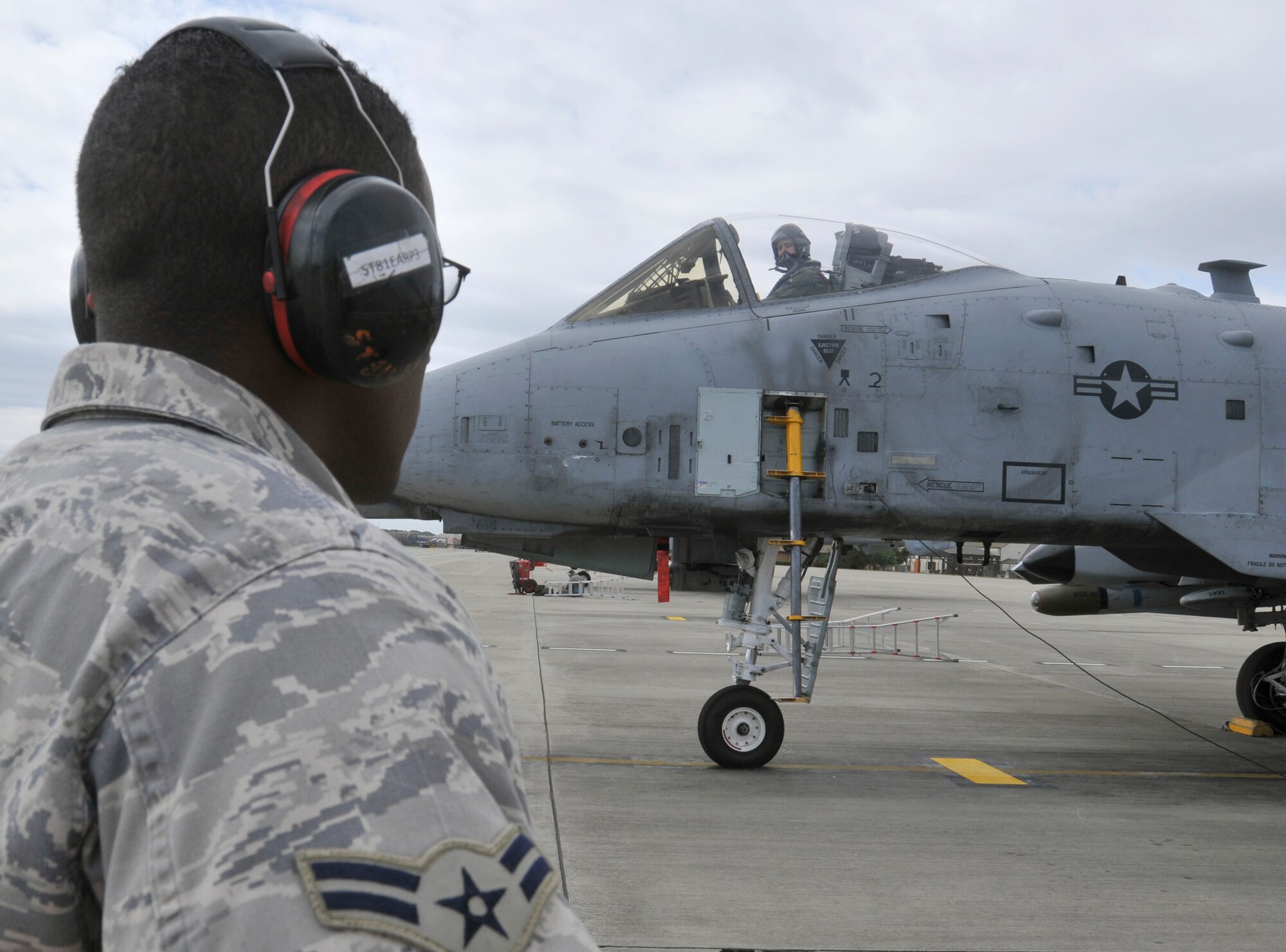 ROYAL AIR FORCE LAKENHEATH, England - Airman 1st Class Derek McElroy, 81st Air Mobility Unit, 52nd Aircraft Maintenance Squadron weapons loader, observes an A-10 Thunderbolt II during pre-flight checks at RAF Lakenheath, Aug. 10, 2011. The A-10s are here in support of a U.K.-led exercise. (U.S. Air Force photo/Senior Airman Tiffany M. Deuel)