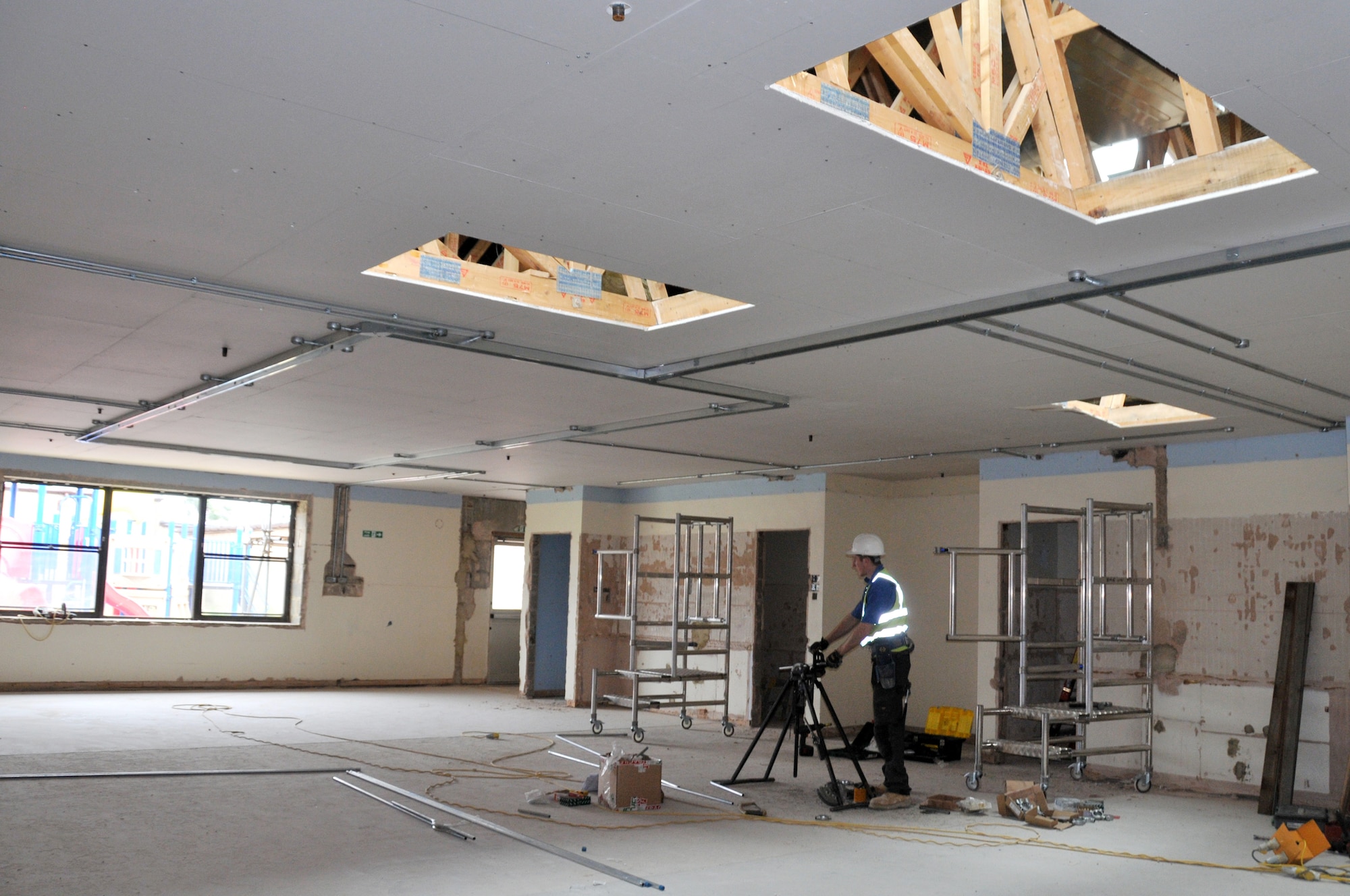 ROYAL AIR FORCE LAKENHEATH, England - A construction worker moves equipment during the renovation of the RAF Lakenheath Child Development Center East on Aug. 11, 2011. The renovation started in February and is projected to be completed by March 2012. (Air Force photo/Senior Airman Lausanne Morgan)
