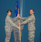 Col. Caroline Evernham (left), 916th Operations Group commander, passes the 916th Operations Support Squadron guidon to Lt. Col. Douglas Miller, the new squadron commander. Miller comes from Travis Air Force Base, Calif. (USAF photo by TSgt. Scotty Sweatt, 916ARW/PA)