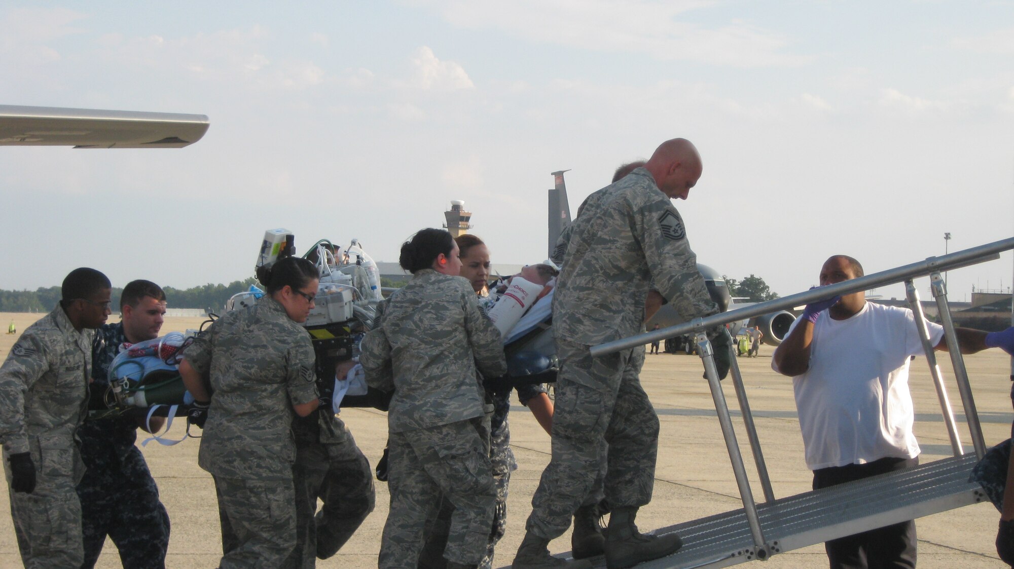 A critical care patient is moved to the Walter Reed patient transport vehicle. Sometimes these liters can weigh more than 500 lbs. Combat troops typically arrive here within 72 hours of suffering a severe battlefield injury. The aeromedical staging facility at Joint Base Andrews, Md. is the primary East Coast hub for aeromedical evacuation aircraft returning sick or injured patients  from Europe, Africa, and the Middle East to the United States for care.  (U.S. Air Force photo by Melanie Moore)
