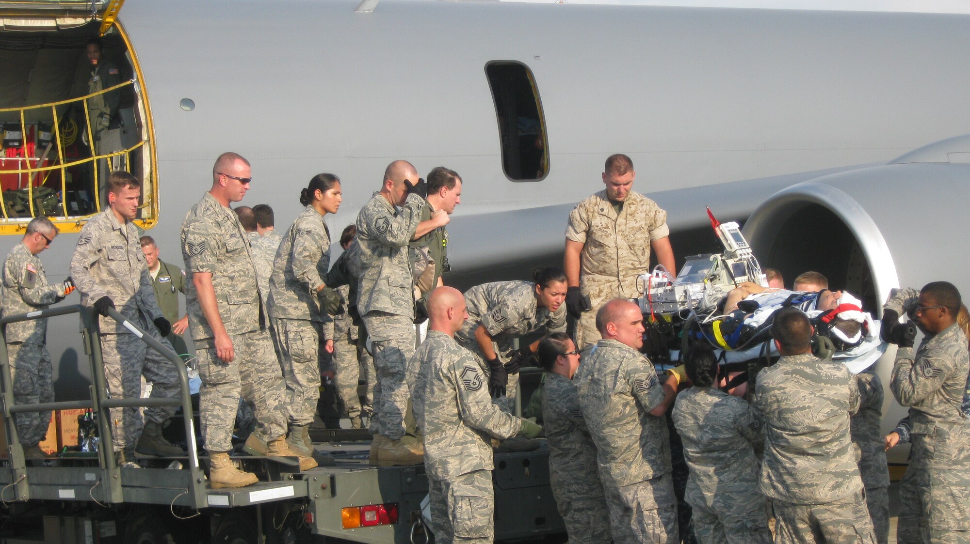 A wounded patient is offloaded from a KC-135 on the Joint Base Andrews, Md. flightline by a multitude of aeromedical staging facility personnel who know that every second counts in the treatment of Wounded Warriors arriving from Central Command's theater of operations. Combat troops typically arrive here within 72 hours of suffering a severe battlefield injury. The aeromedical staging facility at Andrews is the primary East Coast hub for aeromedical evacuation aircraft returning sick or injured patients  from Europe, Africa, and the Middle East to the United State for care.  (U.S. Air Force photo by Melanie Moore)
