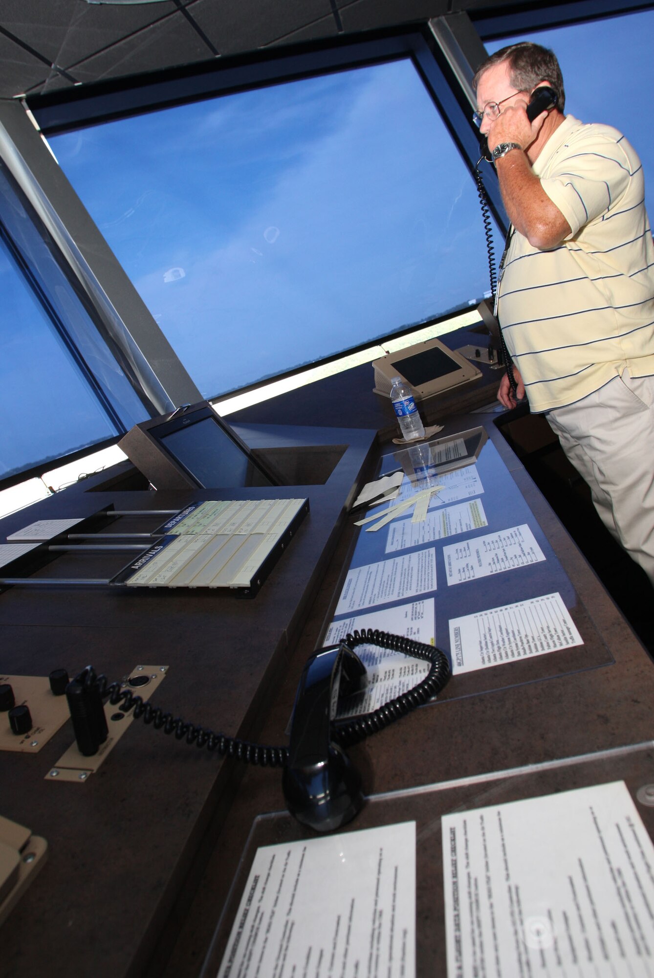 A member from tower personnel works within the top cab overlooking the Marietta skyline. The larger top cab provides greater visibility to parts of the Clay Army Guard ramp and portions of the runway training area, not previously visible from the old tower. (U.S. Air Force photo/Don Peek)