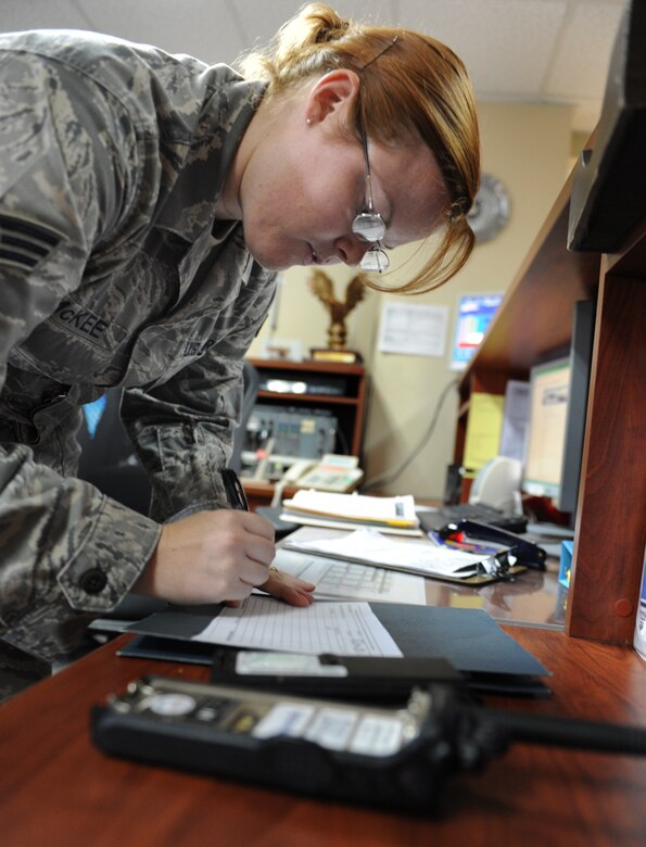 Senior Airman Maria McKee, 39th Operations Squadron airfield management shift lead, fills out a hand receipt for a land mobile radio Aug. 10, 2011, at Incirlik Air Base, Turkey. Airfield management use LMRs to communicate with the air traffic control tower to ensure they do not cross a runway with an aircraft taking off or landing. (U.S. Air Force photo by Senior Airman Anthony Sanchelli/Released)