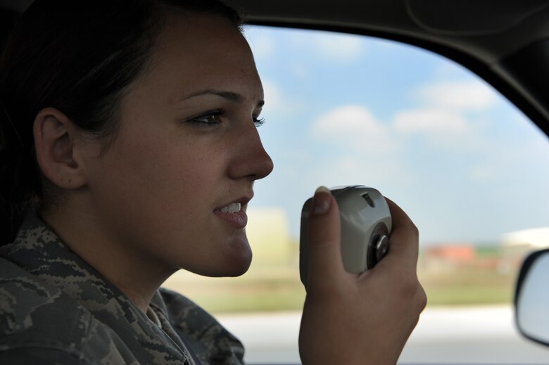 Airman Erika Strachan, 39th Operations Squadron airfield management apprentice, talks with the tower to obtain clearance to cross an active runway Aug. 10, 2011, at Incirlik Air Base, Turkey. Airfield management oversees all operations on the airfield to include filing flight plans, initiating search and rescue operations, managing the bird aircraft strike hazard program and ensuring all vehicle operators are qualified to drive on the flightline. (U.S. Air Force photo by Senior Airman Anthony Sanchelli/Released)