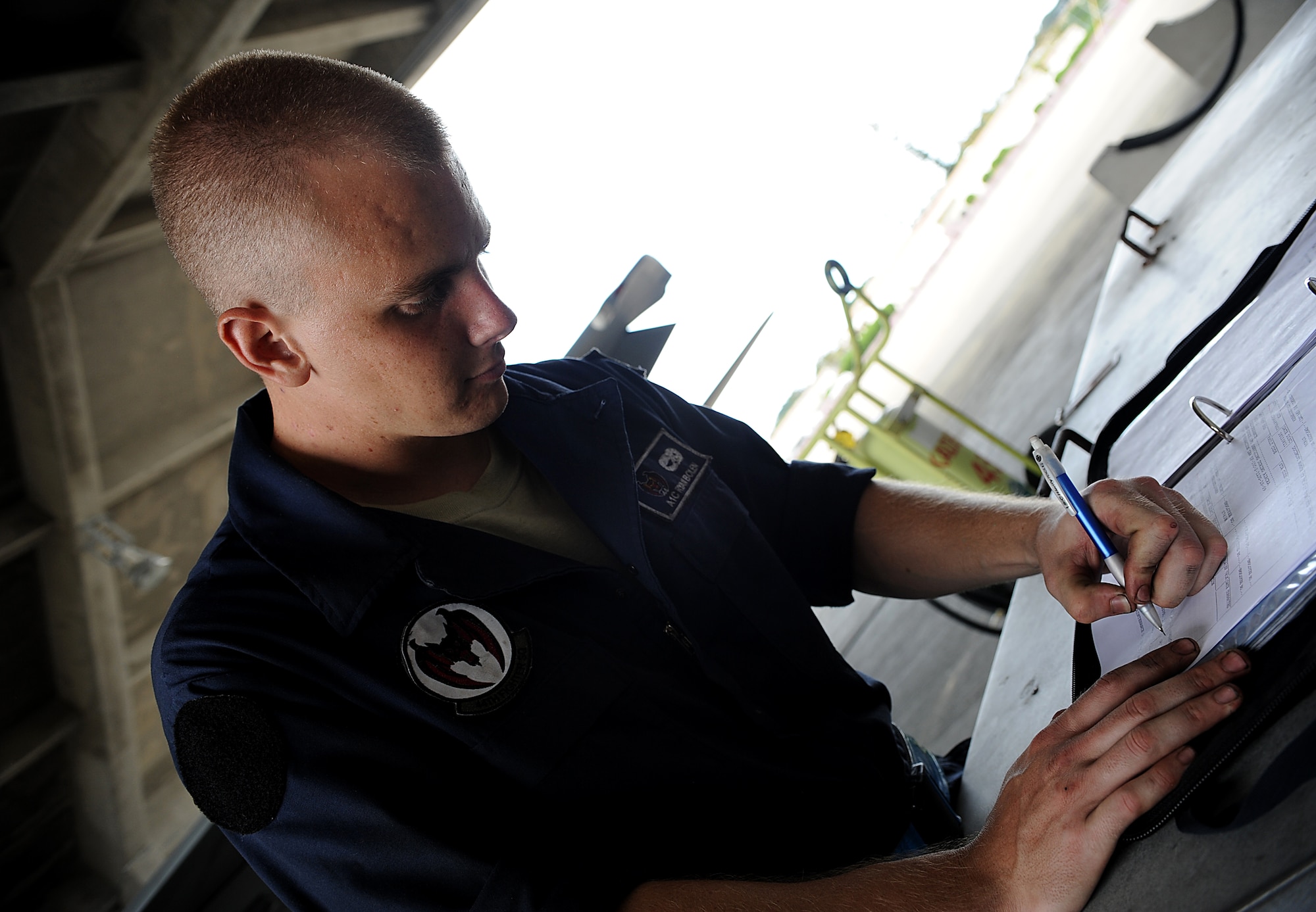 Airman 1st Class Ryan Bolen,18th Aircraft Maintenance Squadron crew chief,  fills out a 781A, maintenance discrepancy and work document, Aug. 10, Kadena Air Base, Japan. These forms and the maintenance they track are a part of Beverly High 11-6, a Local Operational Readiness Exercise. During the LORE, Airmen sharpen skills required during normal and contingncy operations. (U.S. Air Force photo/Staff Sgt. Christopher Hummel)