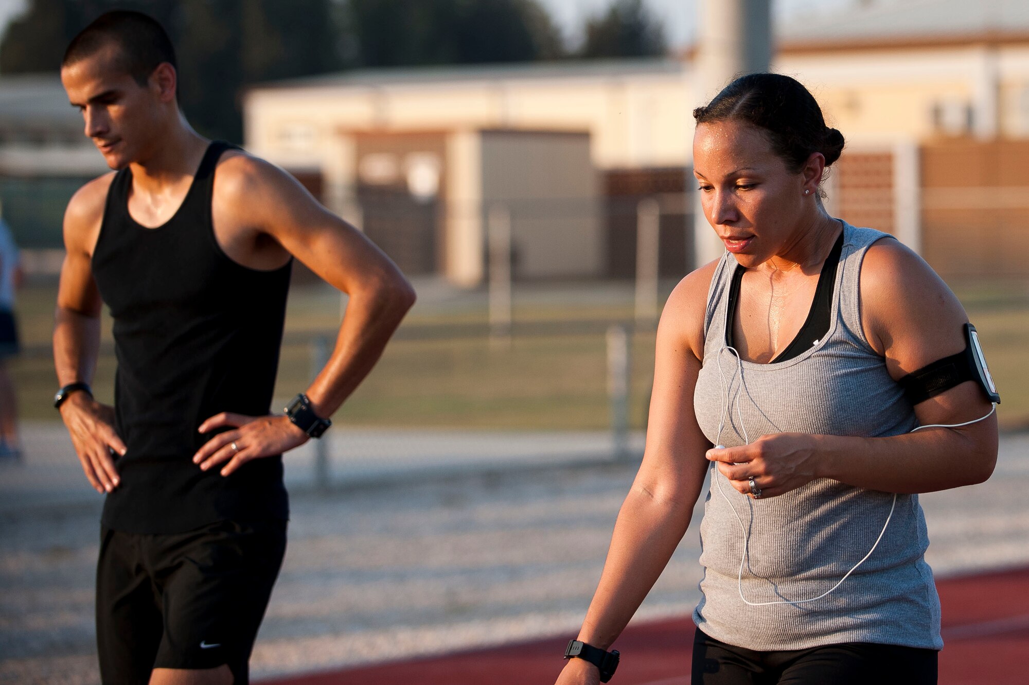 Staff Sgt. Joshua Acosta, 39th Logistics Readiness Squadron, and Staff Sgt. Nicole Dunlap, 39th Medical Operations Squadron, cool down following an Incirlik Running Club session at the track Aug. 10, 2011, at Incirlik Air Base Turkey. The Incirlik Running Club's overall goal is to prepare Airmen for Incirlik's Half Marathon and Istanbul's Marathon. (U.S. Air Force photo by Airman 1st Class Clayton Lenhardt/Released)