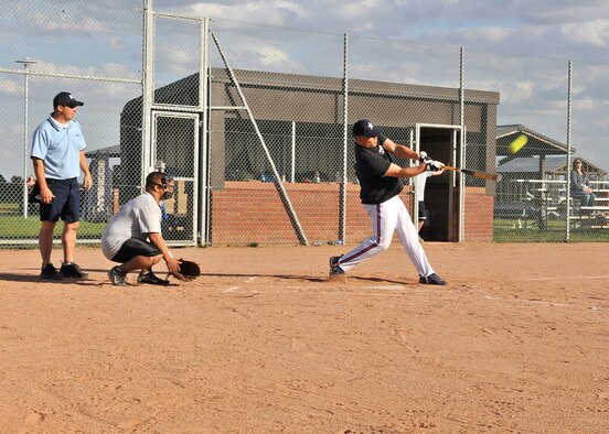 RAF MILDENHALL, England -- Alex Ganster, 488th Intelligence Squadron, hits the ball out-of-the-park during the Team Mildenhall Intramural Softball Championship here Aug. 9, 2011. The 488th IS/95th Reconnaissance Squadron team went on to win against the 352nd Special Operations Group 20-8.  (U.S. Air Force photo/Staff Sgt. Tabitha M. Lee)