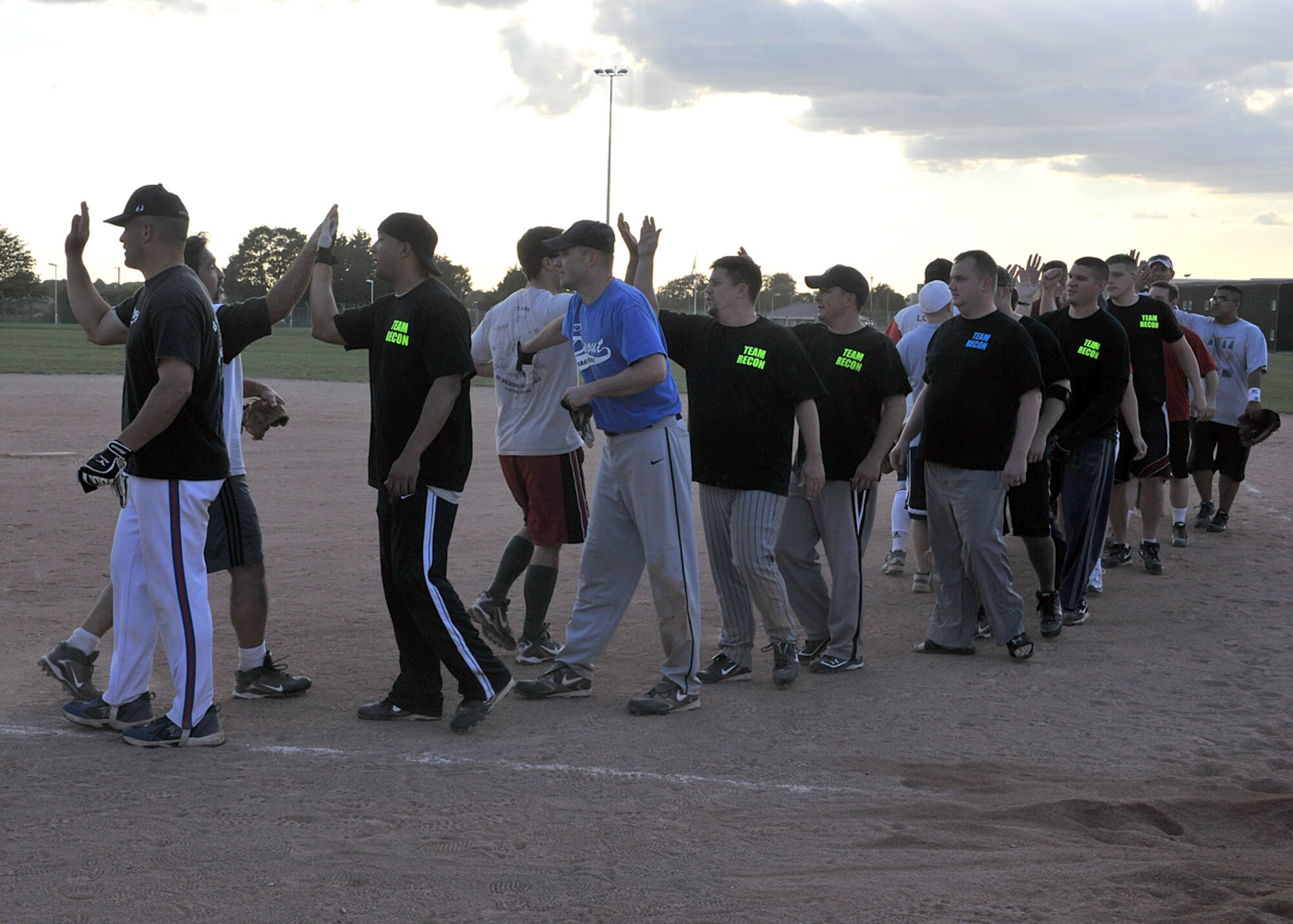 RAF MILDENHALL, England -- Members of the 488th Intelligence and 95th Reconnaissance Squadrons, and the 352nd Special Operations Group softball teams congratulate each other after the Team Mildenhall Intramural Softball Championship here Aug. 9, 2011.  The 488th IS/95th RS beat the 352nd SOG 20-8. (U.S. Air Force photo/Staff Sgt. Tabitha M. Lee)