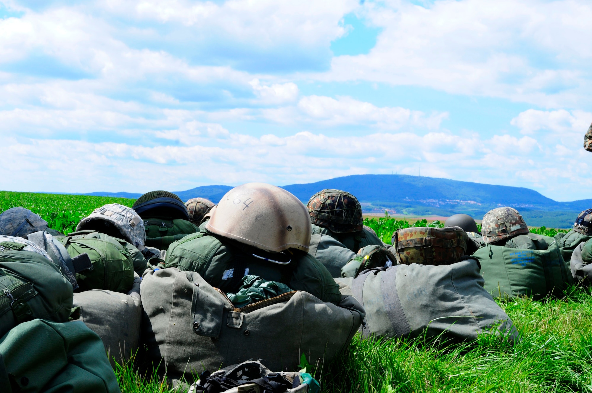 Gear used by U.S. and NATO service members lay near the designated drop zone during International Jump Week in Marnheim, Germany, Aug. 10, 2011. Six NATO countries participated in the annual event to support one of United States Air Forces in Europe's top priorities; building partnership capacity. More than 200 U.S. and NATO jumpers participated in the week-long training. (U.S. Air Force photo by Airman 1st Class Kendra Alba)