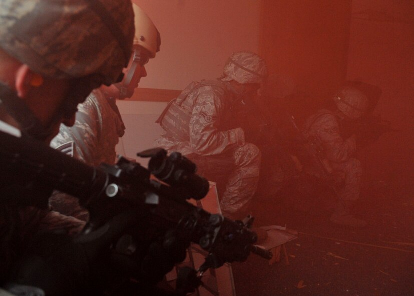 14 of the 27 Airman who volunteered, remain here, August 10. Day two and three of the QRT training, rigorous physical training continued as obstacles increased with difficulty testing not only their strength but also their capabilities to act as a cohesive squad. SF Airmen were taught how to breech/clear buildings and received certification in the use of simulated ground burst projectiles. Day four SF Airmen performed active shooter scenarios on a bus.  Physical training sessions were themed in memory of the 31 warriors lost in Afghanistan, August 7, by each volunteer completing 31 of each exercise throughout the course. A QRT member provides immediate response to any high risk situation on Osan Air Base to include barricaded suspects, workplace violence, domestic violence and abuse response, school violence, and disaster response. (U.S. Air Force Photos by/ Senior Airman Adam Grant)