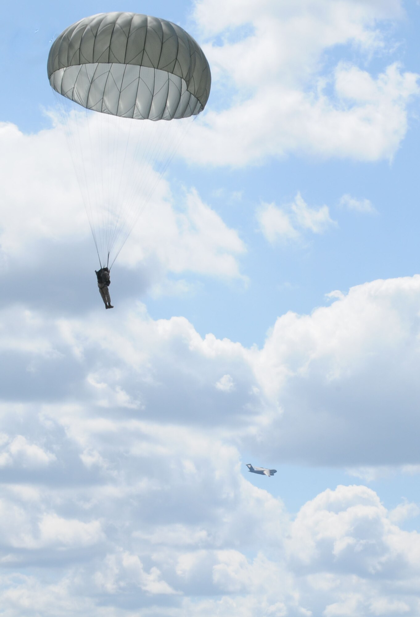 A U.S. military member parachutes from a C-17 Globemaster III, toward a drop zone during International Jump Week, Aug. 10, 2011 in Marnheim, Germany. Six NATO countries participated in the annual event to support one of United States Air Forces in Europe's top priorities; building partnership capacity. More than 200 U.S. and NATO servicememebers participated in the week-long training. (U.S. Air Force photo by Airman 1st Class Kendra Alba)