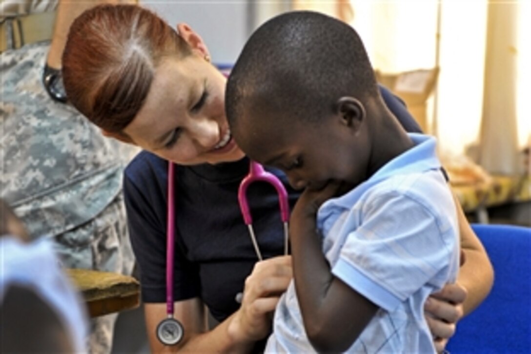 U.S Navy Lt. Sonia Mochan examines a young child during New Horizons 2011, a medical training exercise, in Brokopondo, Suriname, Aug. 10, 2011. Mochan is a physician with the 59th Medical Wing at Lackland Air Force Base, Texas.