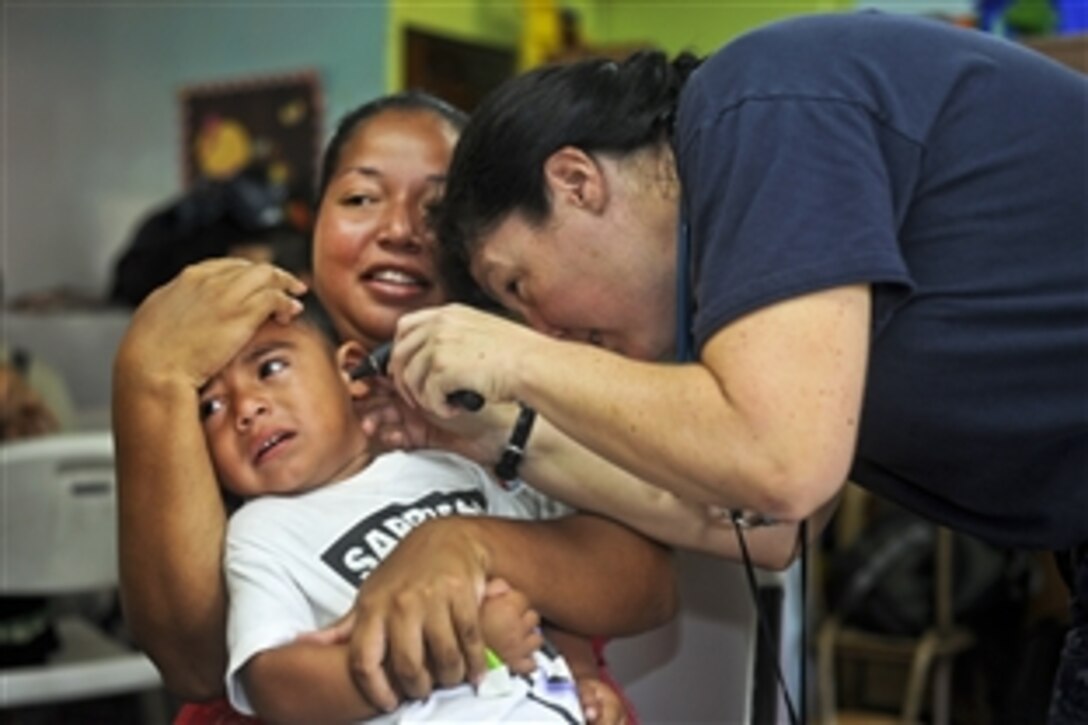 U.S. Navy Cmdr. Laurie Hale examines a patient at the Escuela Fray Casiano de Madrid medical site during Continuing Promise 2011 in Puntarenas, Costa Rica, Aug. 3, 2011. The five-month humanitarian assistance mission is providing care in the Caribbean, Central and South America.