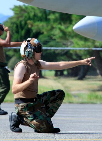 Navy Petty Officer 2nd Class Charles Benavidez, Strike Fighter Squadron 94 ordnance technician, stands by with a radio in hand during a sorti launch on the flightline here Aug 11.  Strike Fighter Squadron is slated to recieve ample amounts of support from Marine Aviaiton Logistics Squadron 12 during their deployment to Kadena Air Base, Okinawa.