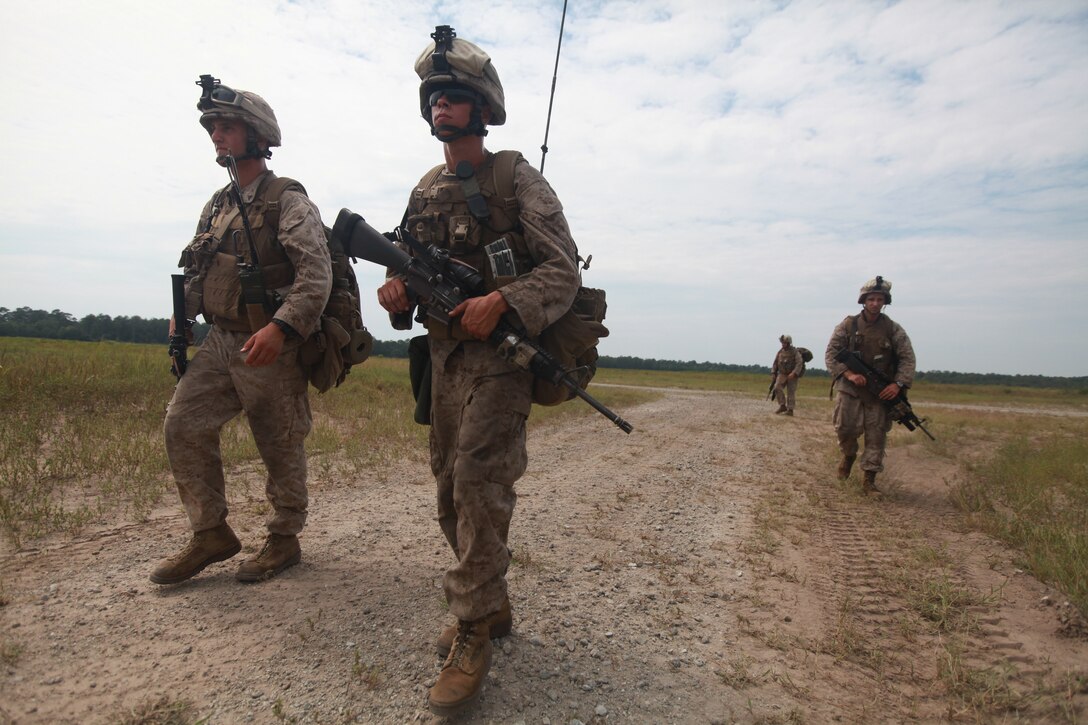 Lance Corporals Michael Harner (left) and Timothy Coker, riflemen with Bravo Company, 1st Battalion, 2nd Marine Regiment, 2nd Marine Division, conduct a mile-long squad patrol during a field exercise here, Aug. 11. The training was part of a week-long operation to prepare Marines and Sailors for their upcoming deployment with the 24th Marine Expeditionary Unit.