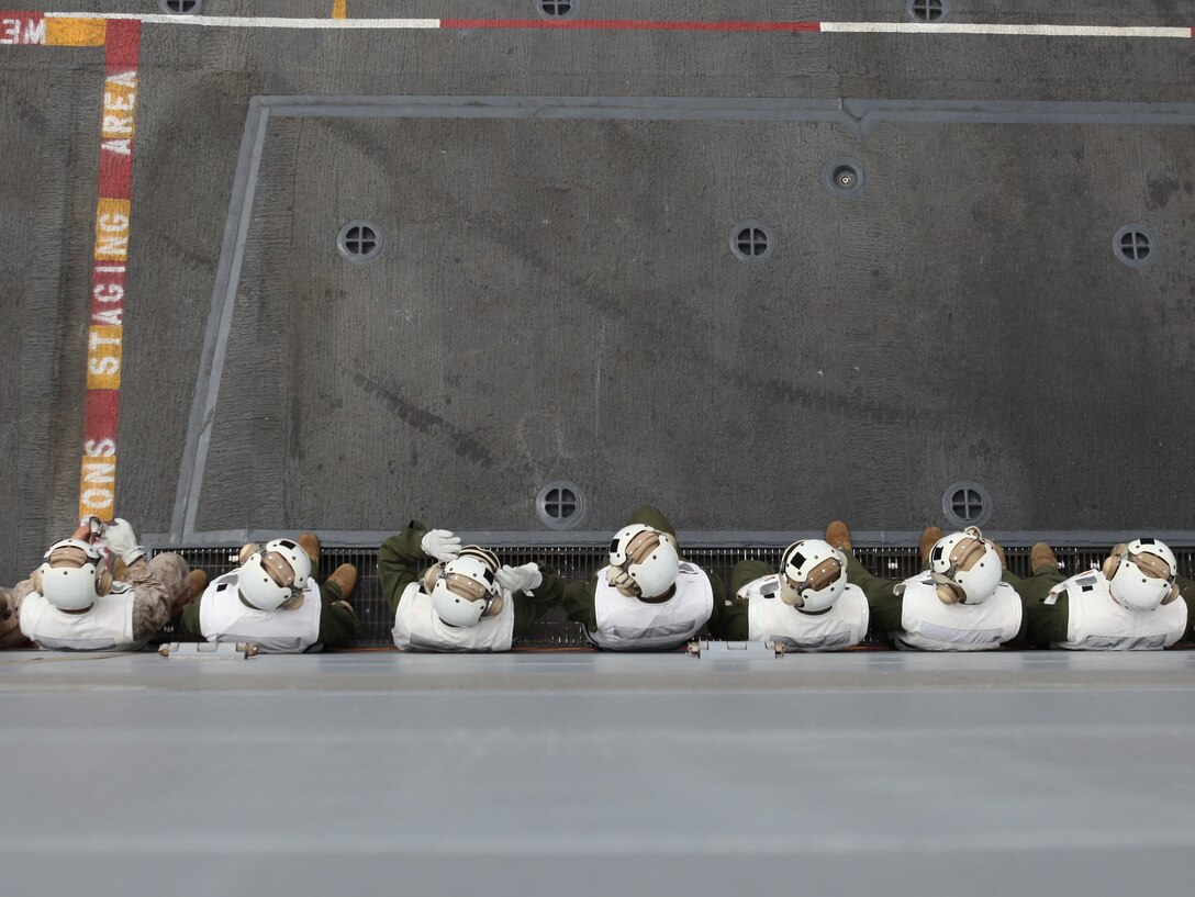 Marine cargo handlers with the 11th Marine Expeditionary Unit wait for aircraft to land on USS New Orleans off Southern California's coast Aug. 11. The Marines are participating in a 12-day sea-based training exercise, the unit's first since becoming a complete Marine air ground task force in May.