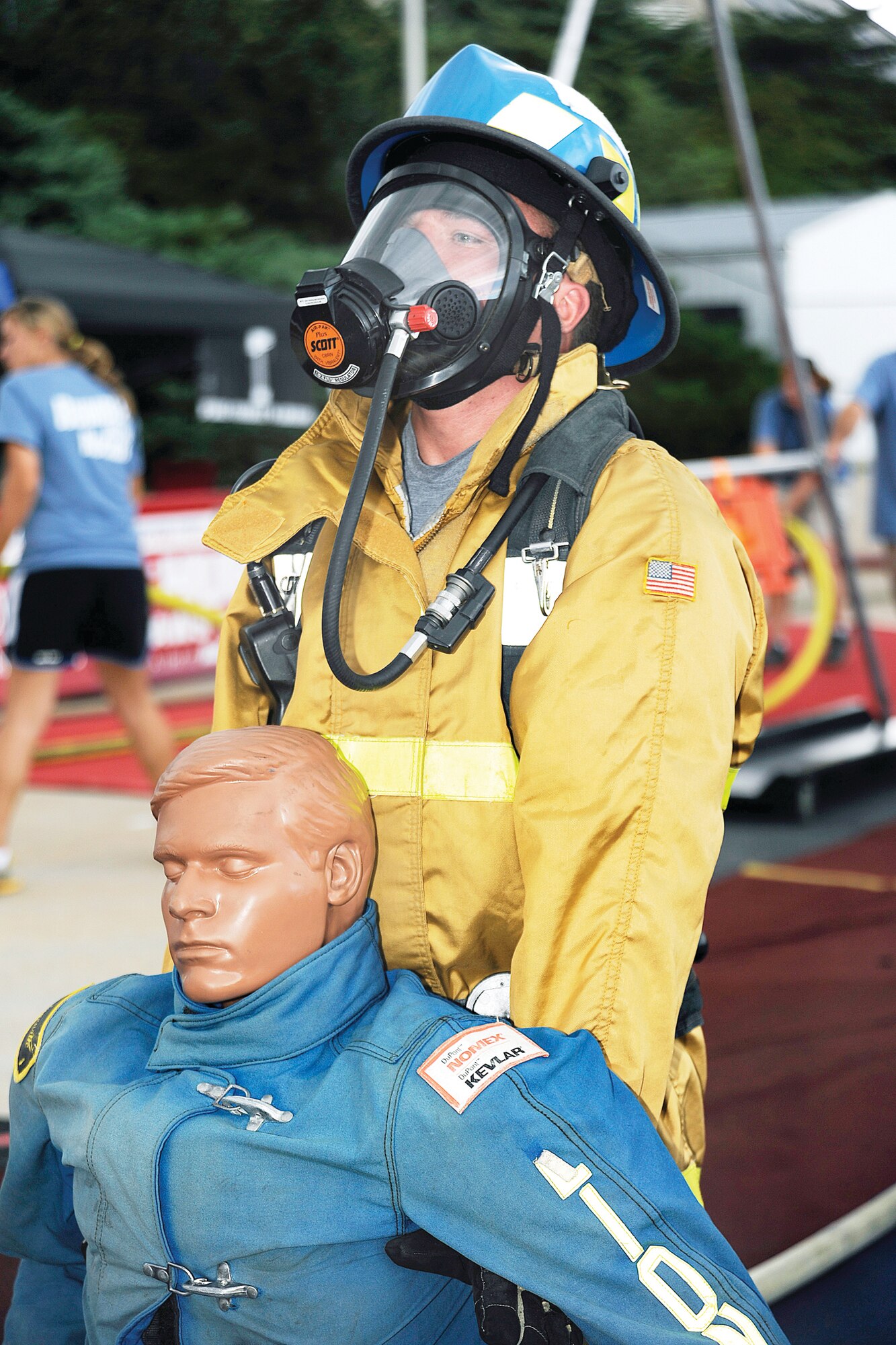 Air Force Academy Firefighter Airman 1st Class Andrew Spangenberger participates in the victim rescue event during the Firefighter Challenge competition Aug. 6.  Competitors must drag a 175-pound mannequin 100 feet. (U.S. Air Force Photo/Sarah Chambers)