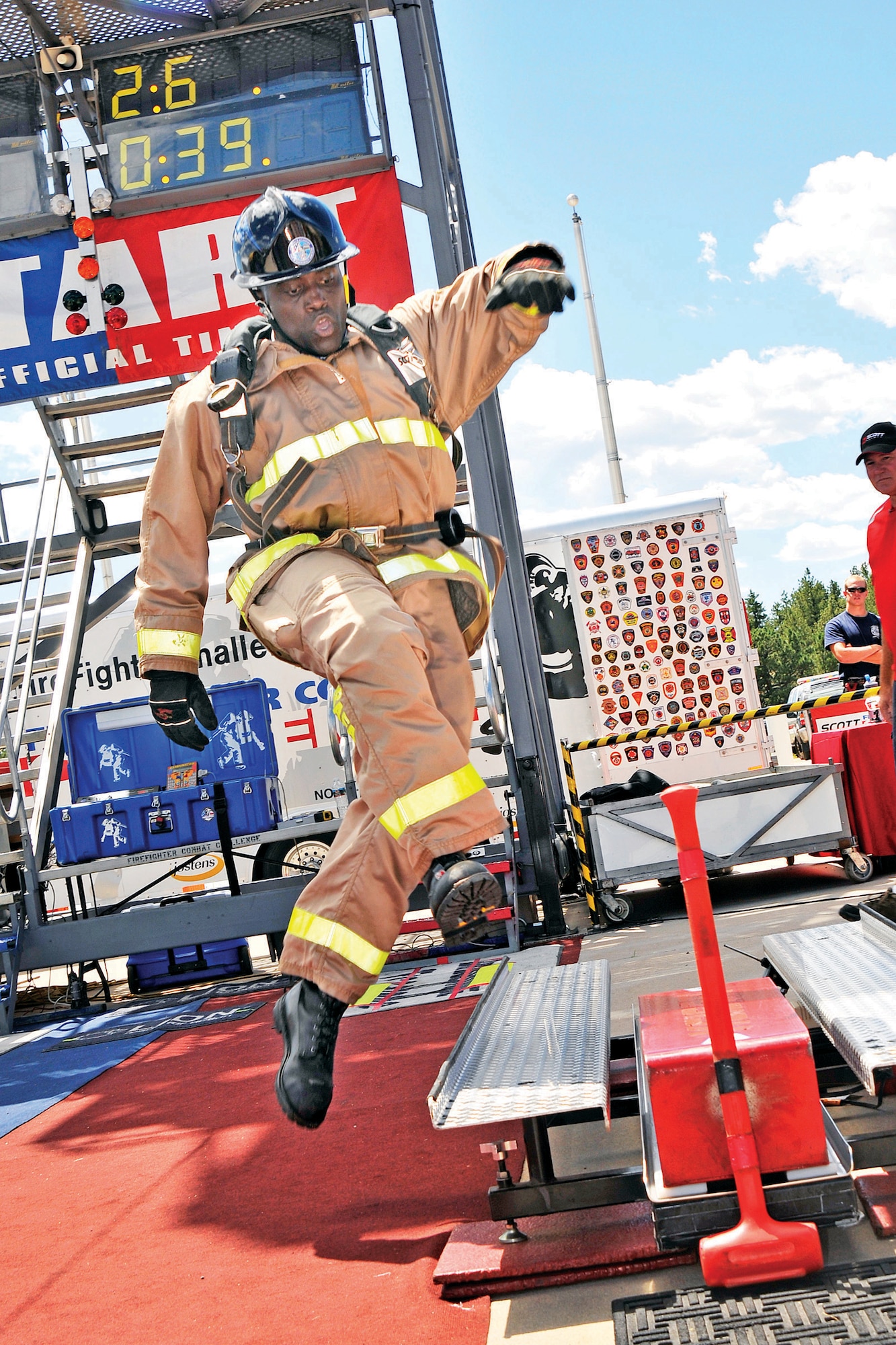 Air Force Academy Firefighter Anthony “Tank” McMurtry participates in the forcible entry challenge, which simulates a firefighter breaking down a door or wall to enter a burning  building. Competitors stand on a 160-pound beam, and use a 9-pound sledge hammer to move it 5 feet (U.S. Air Force Photo/Raymond McCoy)