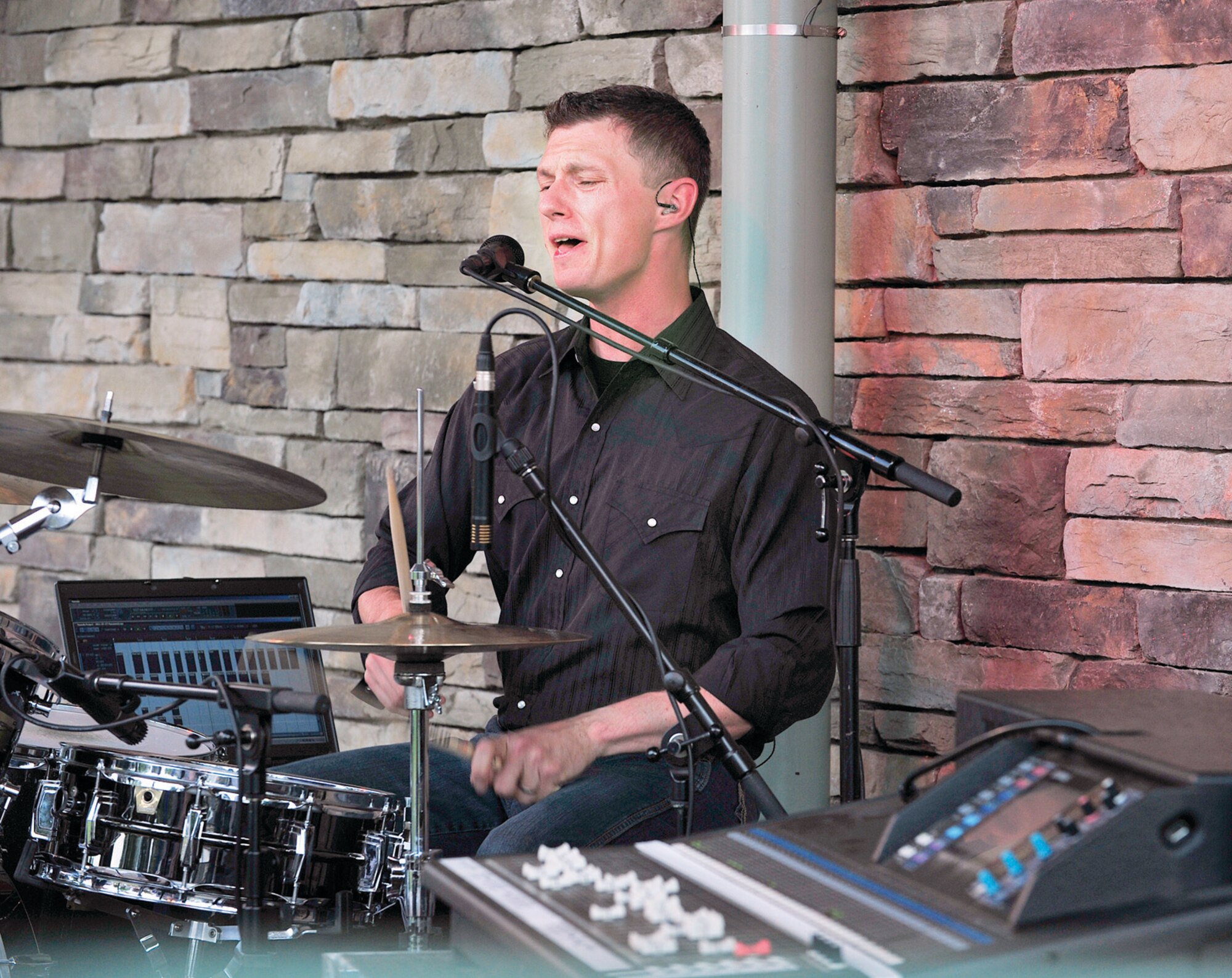 Tech. Sgt. Timothy Stombaugh, Wild Blue Country’s drummer, performs at a concert in the park in Monument, Colo., July 28.  (U.S. Air Force Photo/Bill Evans)