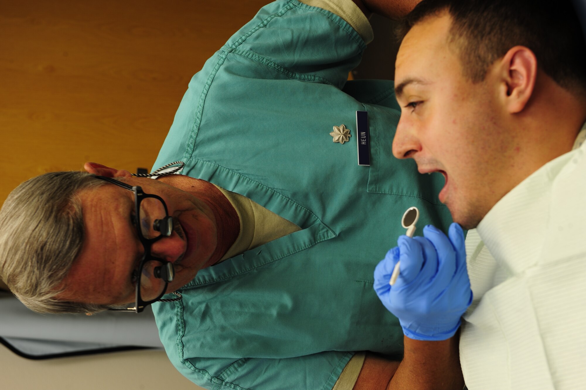 Lt. Col. (Dr.) Robert Heun, 44th Aeromedical Dental Squadron, examines Senior Airman Jason Schultz, a health services administrator. Reservists are required to visit a military dentist every three years for a visual exam and assessment as a part of medical readiness. (U.S. Air Force Photo by SrA Martha Whipple, 44th Fighter Group Public Affairs)
