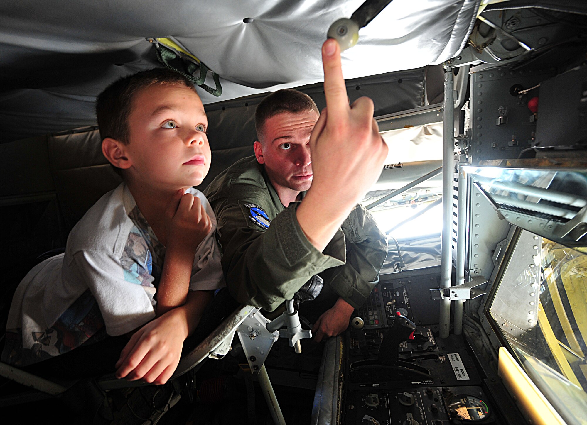 Senior Airman Chris Reed, 344th Air Refueling Squadron boom operator, shows Jesse, 9, how KC-135 Stratotanker boom operators refuel aircraft during the “Big for a Day” event Aug. 12, 2011, at McConnell Air Force Base, Kan.  With 63 assigned KC-135s, McConnell is the largest tanker base in the world.  (U.S. Air Force photo/ Senior Airman Courtney Witt)