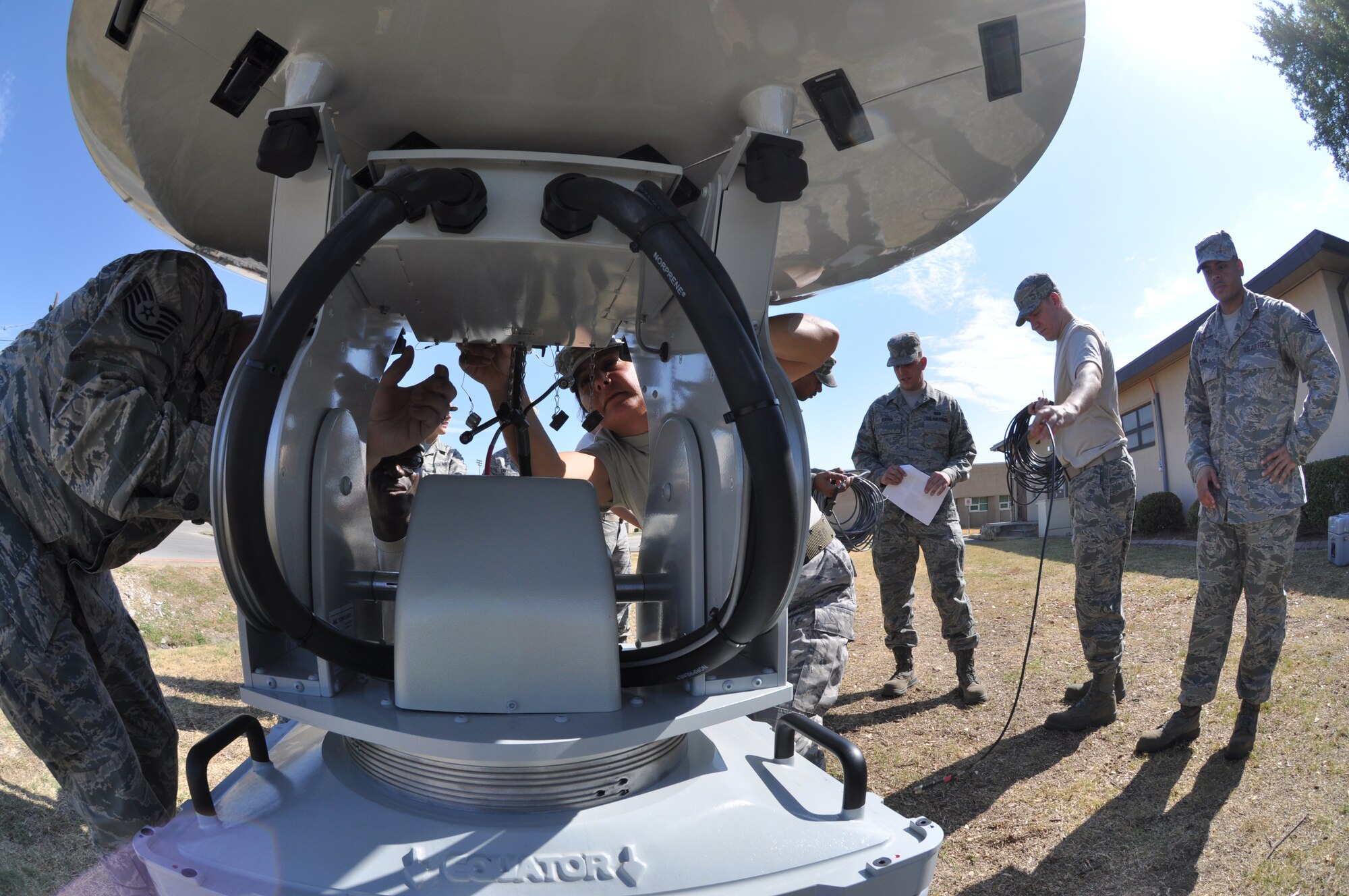 Tech Sergeant Christopher Gingrich and Senior Airmen Rosemary Robertson, from the 301st Comm Flight, hook up cables to the Joint Incident Site Communications Capability being assembled for a training exercise at Naval Air Station Fort Worth Jont Reserve Base August 9, 2011. (U.S. Air Force photo by Senor Airmen Jacob Jimenez/482d Fighter Wing Public Affairs)