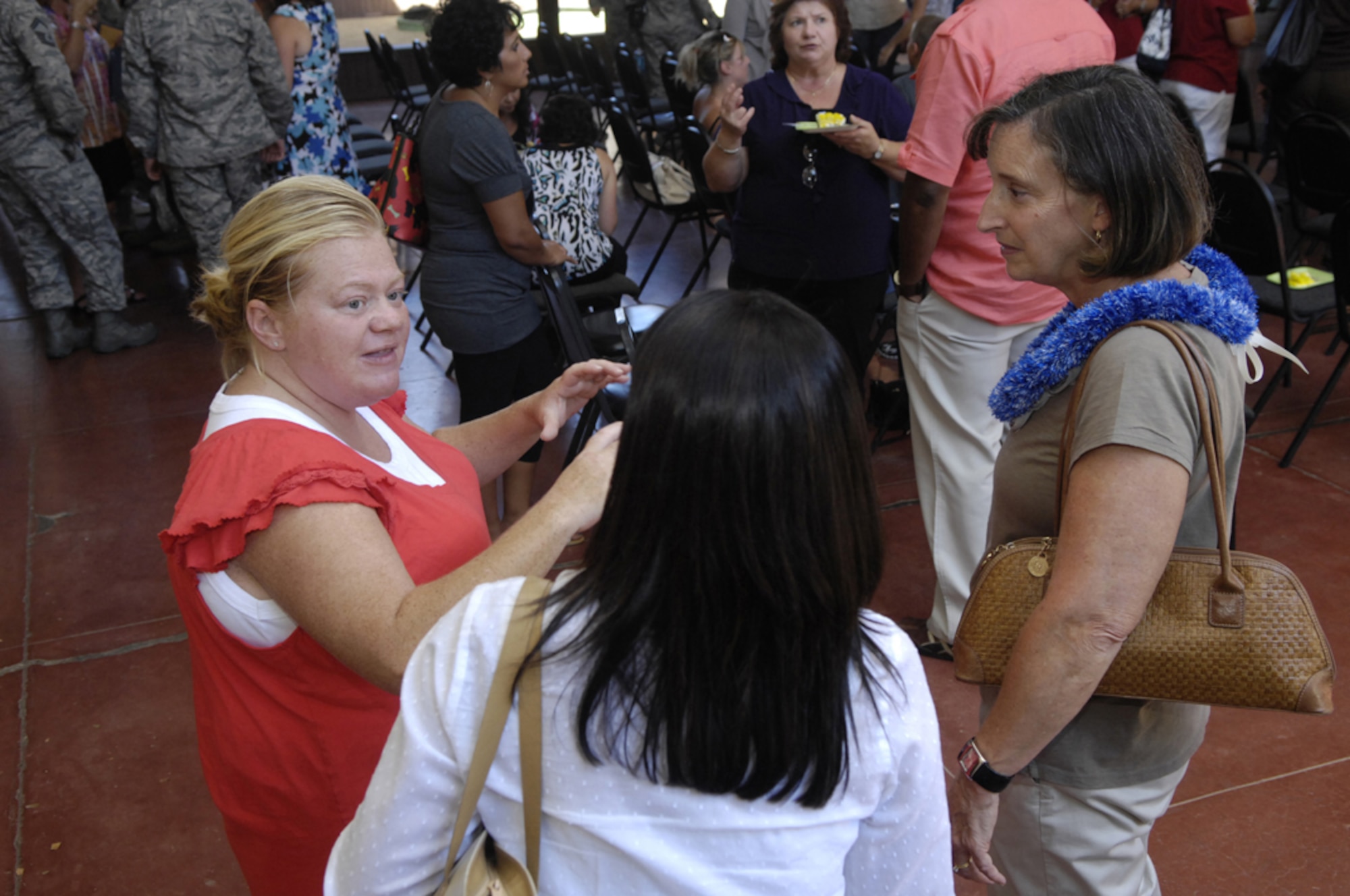 Terri Hornbuckle (left) talks with Mrs. Shelley North (right), wife of Gen. Gary North, Commander, Pacific Air Forces, during the 1st Annual Joint Base Pearl Harbor-Hickam, Hawaii, Volunteer Appreciation Ceremony on Aug. 5.  Mrs. Hornbuckle was recognized as Spouse of the Year, and she and her husband, Tech. Sgt. Michael Hornbuckle, PACAF Band member, received Family of the Year recognition. (U.S. Air Force photo/ David D. Underwood, Jr.)
