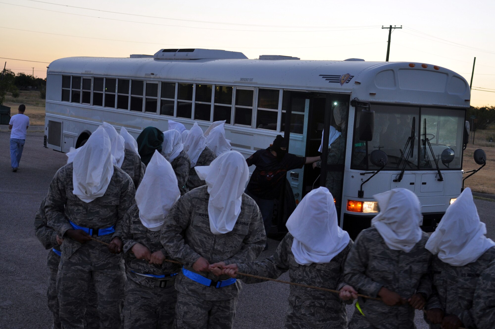 Chaplain candidates line up outside their bus during a simulated terrorist attack staged by 610th Security Forces Squadron personnel, from NAS Fort Worth JRB. The simulation was conducted on the grounds of the Army’s Fort Wolters just outside of Mineral Wells, Texas.  The candidates spent two days at the base for training and briefings related to various aspects of military operations.  The training is intended to give the candidates a better understanding of what members of the armed forces face in day to day operations.  (U.S. Air Force photo/Staff Sgt Chris Bolen)