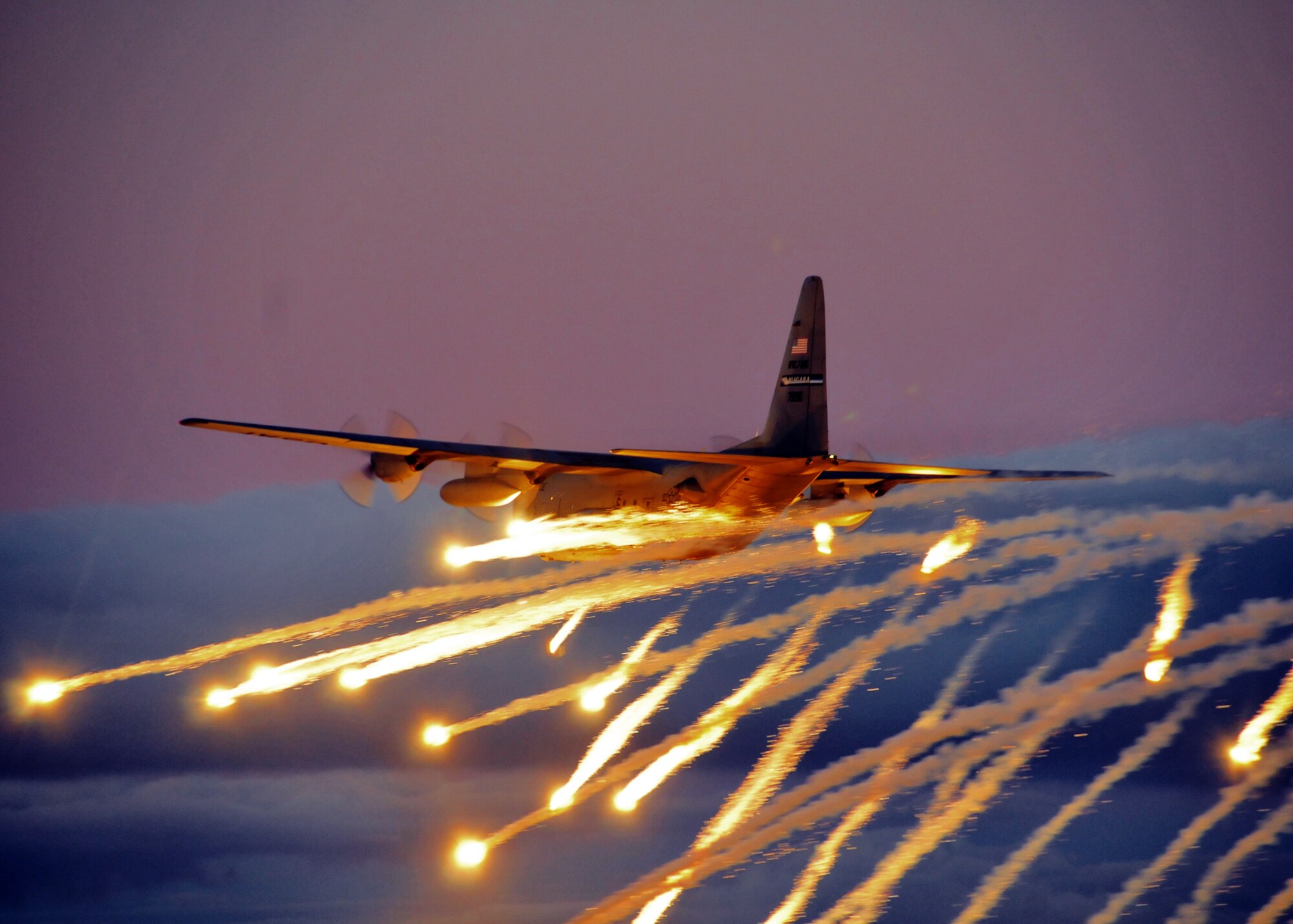 A C-130 from the Niagara Falls Air Reserve Station launches flares over Lake Ontario during a training exercise August 10, 2011, Niagara Falls, NY. Flares can be launched from an aircraft as a defensive measure against hostile forces. (U.S. Air Force photo by Staff Sgt. Joseph McKee)  