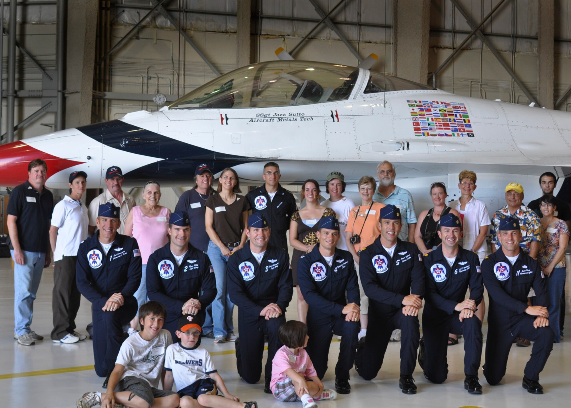 Staff Sgt. Jazz Sutto an aircraft metals technician with the Air Force Thunderbirds air demonstration team is surrounded by friends, family and team members during a Thunderbird FARKLE ceremony held at the 128th Air Refueling Wing, Milwaukee, Wisconsin 7 August, 2011. FARKLE ceremonies, or Family and Relatives, Kinfolk, Loved-ones, and Everyone else, are the Thunderbirds' way of showing their support for fellow team members when an air show takes place in that member's home state. SSgt Jazz Sutto is from Green Bay, Wisconsin. US Air Force photo by: SSgt Jeremy Wilson