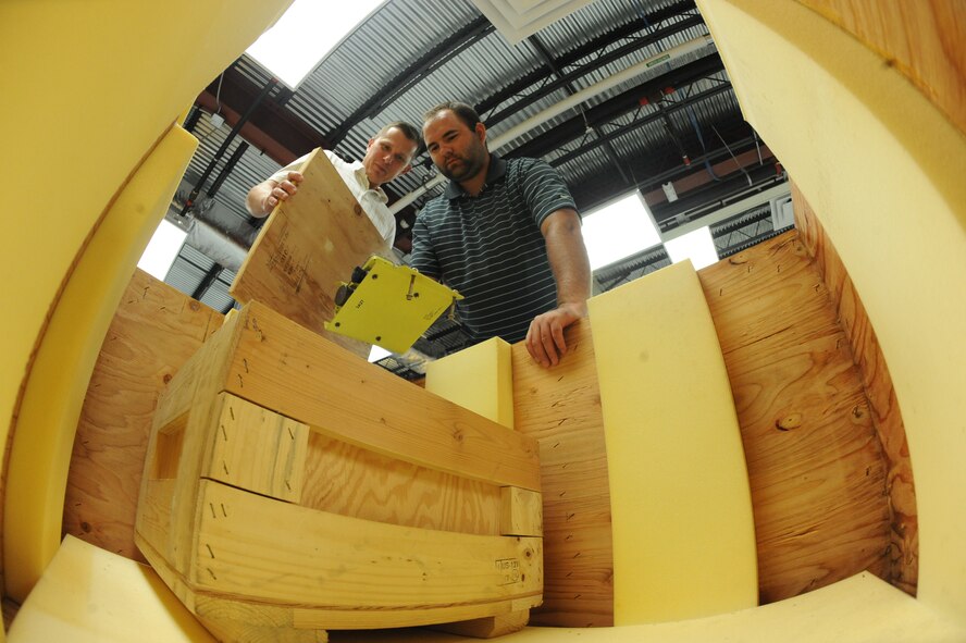 Thomas Foster (left) and Joshuah Dolotina, electronic technicians, pack a box with cruise missile parts in the 49th Test and Evaluation hangar on Barksdale Air Force Base, La., Aug 9.The 49 TES works daily to better the B-52H Stratofortress' hardware, software, weapons, weapon systems, survivability, sustainability and lethality. (U.S. Air Force photo/Airman 1st Class Micaiah Anthony)(RELEASED) 