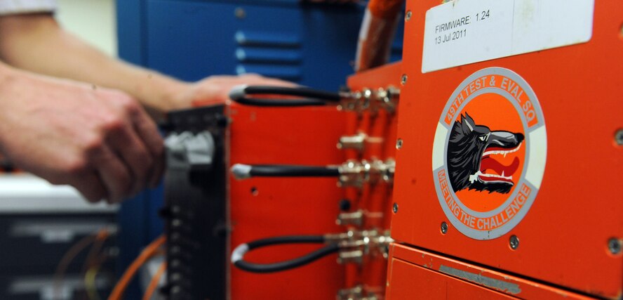 Thomas Foster, electronic technician, makes adjustments to an Airborne Test Instrumentation Data System in the 49th Test and Evaluation Squadron hangar on Barksdale Air Force Base, La., Aug 9. The system is capable of recording audio, video and flight data from the monitors on-board the aircraft. (U.S. Air Force photo/Airman 1st Class Micaiah Anthony)(RELEASED) 