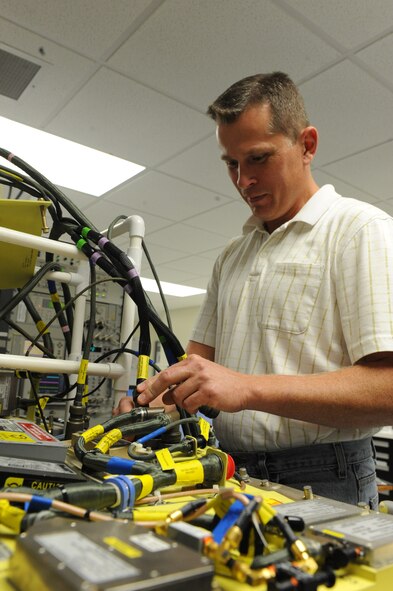 Thomas Foster, electronic technician, works on a cruise missile door in the 49th Test and Evaluation Squadron hangar on Barksdale Air Force Base, La., Aug 9. The door panel is comprised of computers and sensors which allow the missile to communicate with the ground. The panel also allows the missile to be controlled during flight. (U.S. Air Force photo/Airman 1st Class Micaiah Anthony)(RELEASED)
