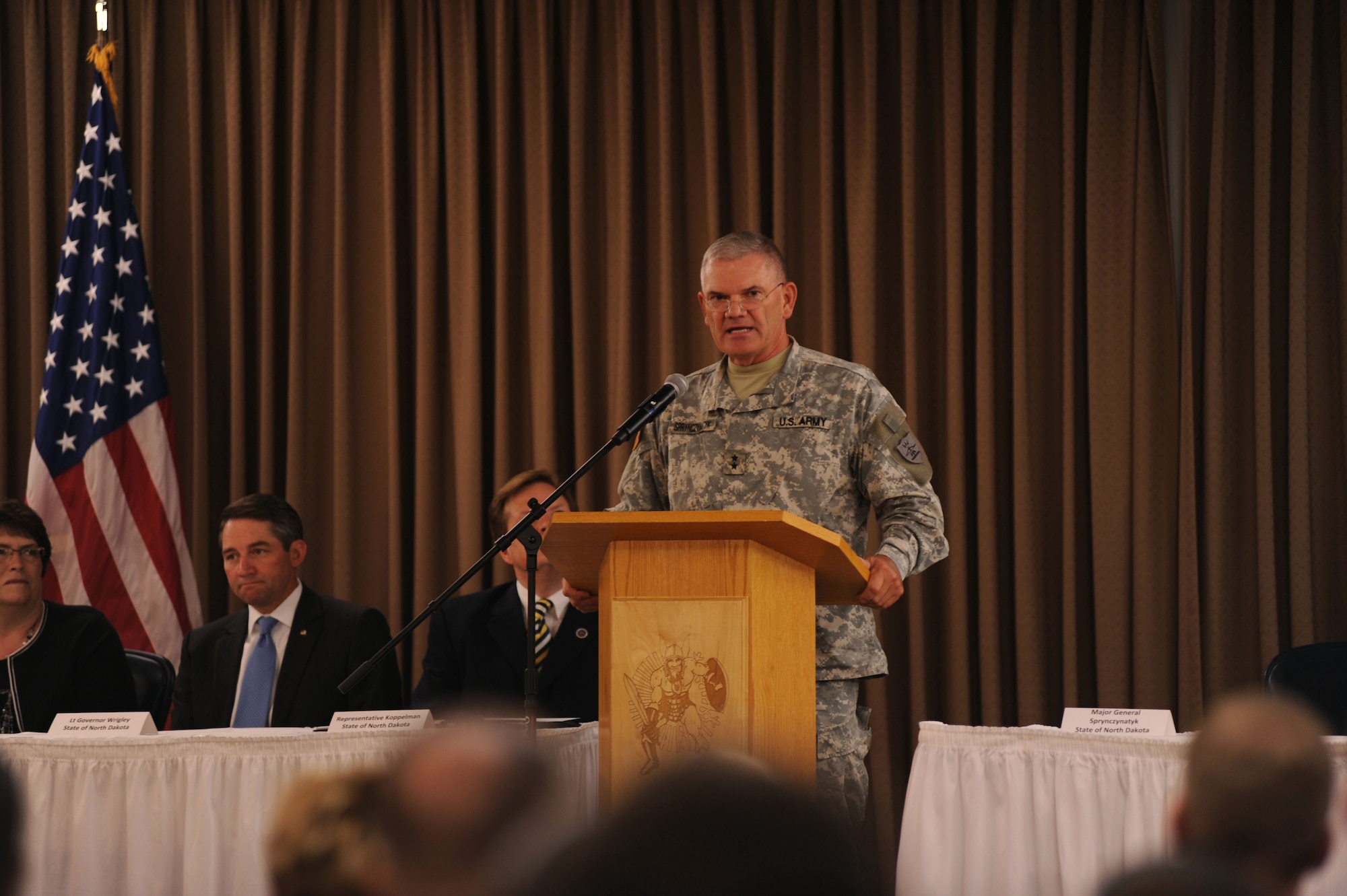 Maj. Gen. David Sprynczynatyk, North Dakota adjutant general, speaks at a conference that marked the beginning of the Interstate Compact on Educational Opportunity for Military Families on Grand Forks Air Force Base Aug 12. This compact eases the transition for children in military families that go from school to school as a result of military mission requirements. (U.S. Air Force photo by Senior Airman Amanda N. Stencil)